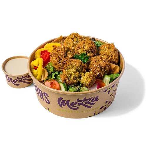 Falafel Lunch Plate with fattoush salad, tahini sauce, hot peppers, and parsley in a Mezza takeout container.