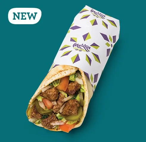 Chimichurri Tahini Steak Wrap with Lebanese-spiced steak, sumac onions, pickles, lettuce, tomatoes, and Chim-Tahini Sauce from Mezza Lebanese Kitchen.