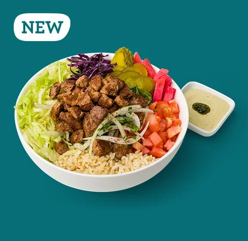 Chimichurri Tahini Steak Bowl with Lebanese spiced steak, sumac onions, lettuce, tomatoes, purple cabbage, pickled turnips, pickles, brown rice, and Chimi-Tahini Sauce from Mezza Lebanese Kitchen.