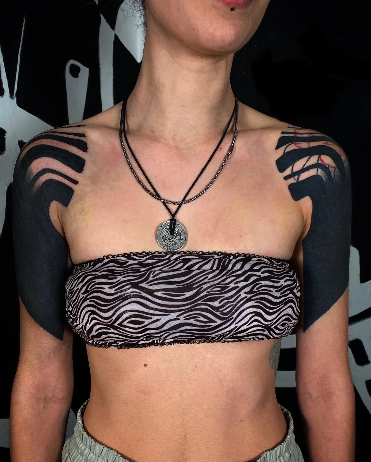 Black work suminagashi tattoo on shoulders and sleeves