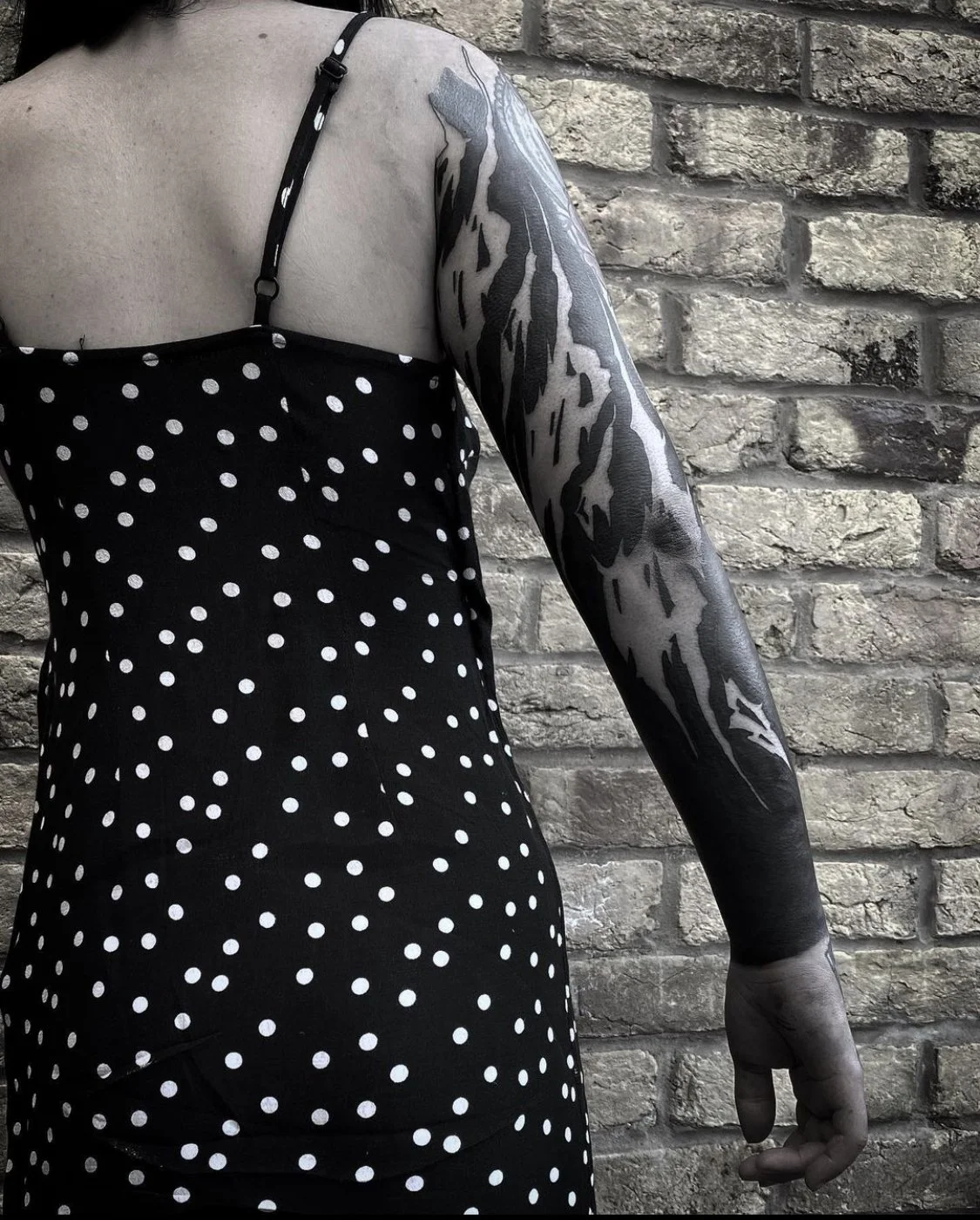 Blackout with negative script sleeve tattoo by Gormex, London tattoo artist