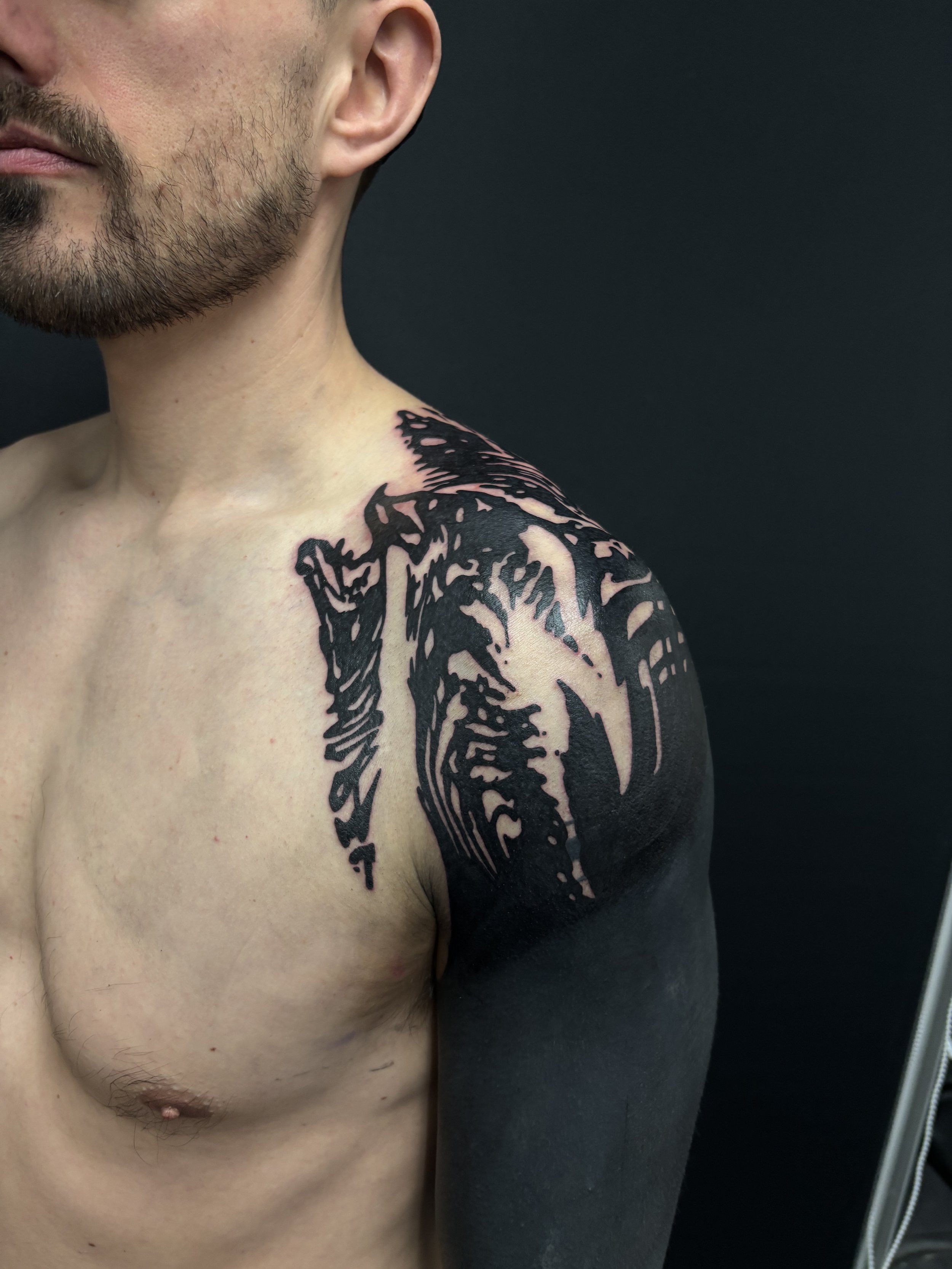 Blackout sleeve and abstract texture on shoulder, done at Seven Doors Tattoo in London