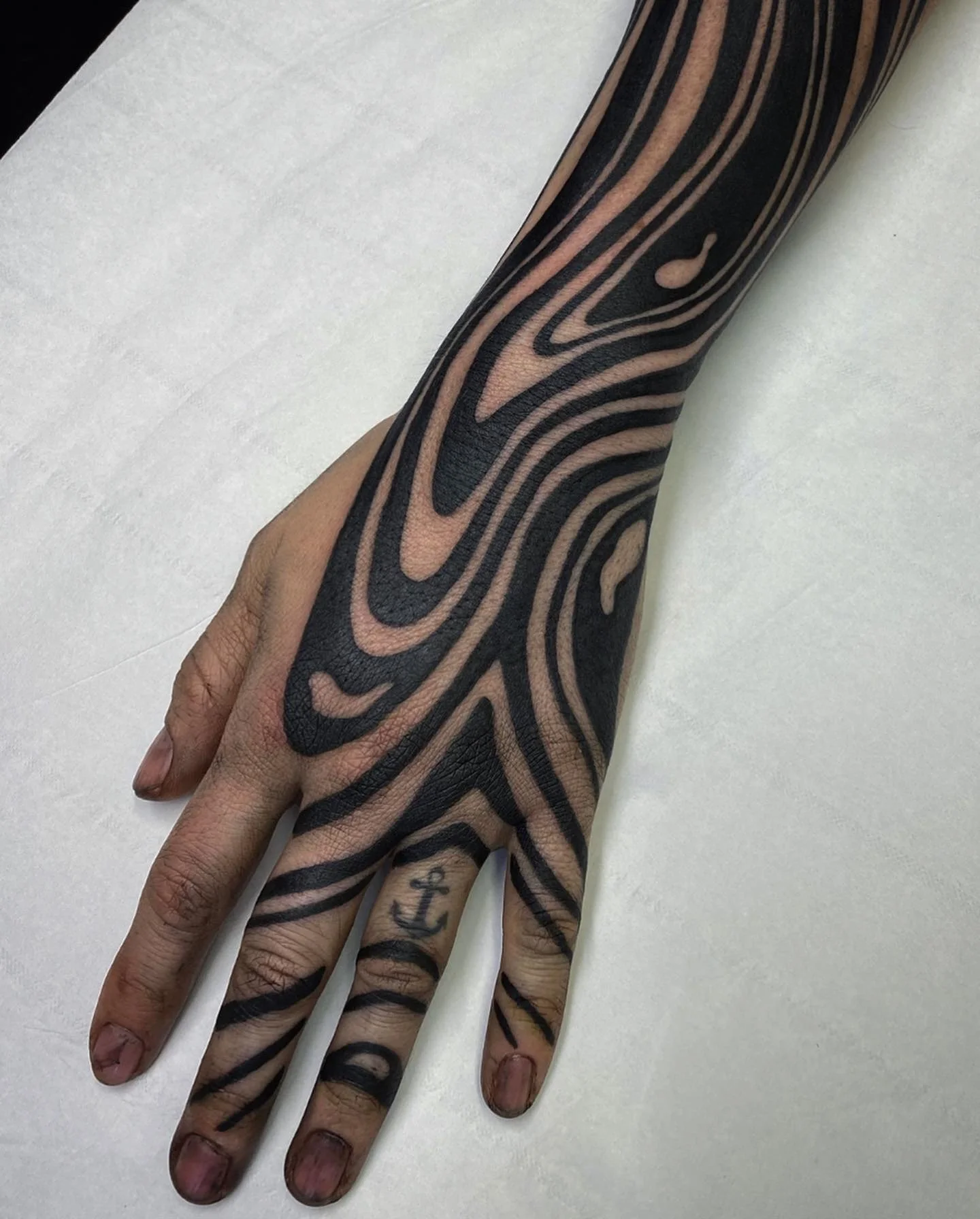 Blackwork hand tattoo inspired by suminagashi concept