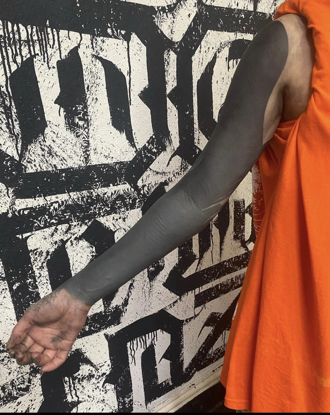 Blackout with negative script sleeve tattoo by Gormex, London tattoo artist