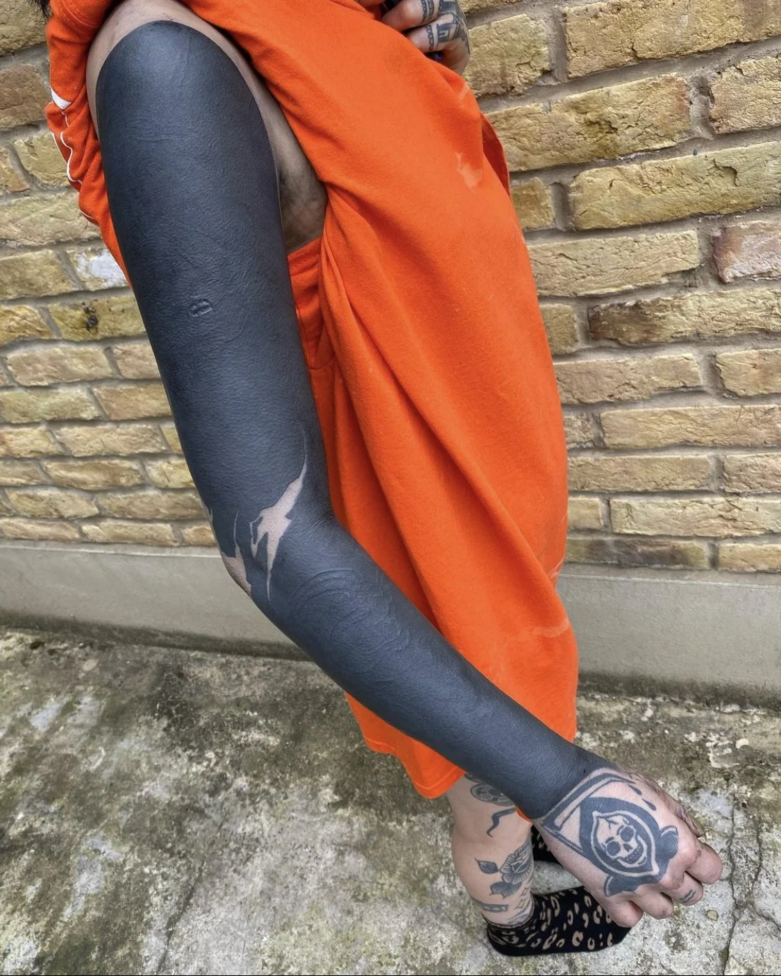 Blackout with negative script sleeve tattoo by Gormex, London tattoo artist