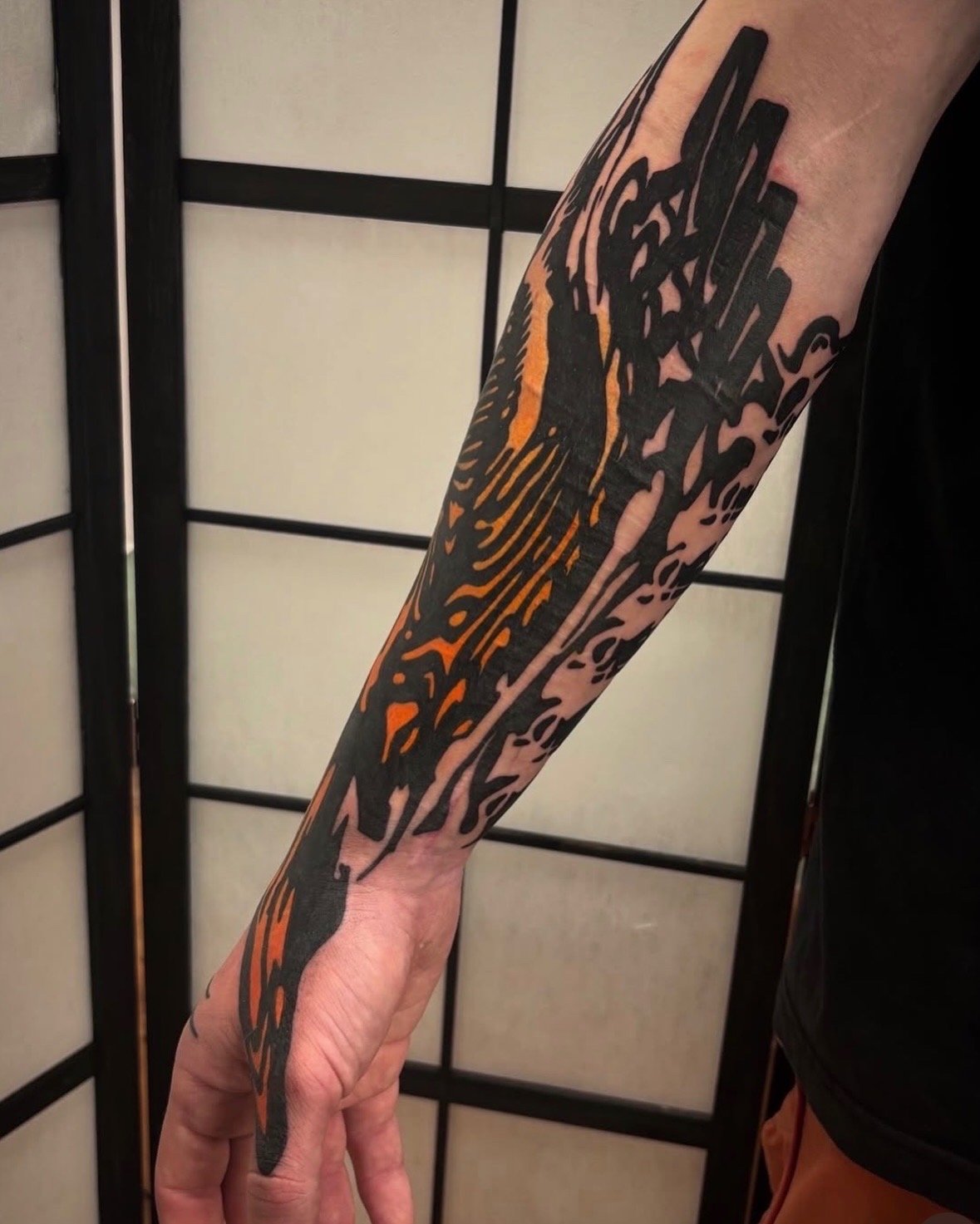 Abstract Blackwork half sleeve and hand, fingers with distorted patterns and textures, and a pinch of orange ink. Done by Görmex in London 