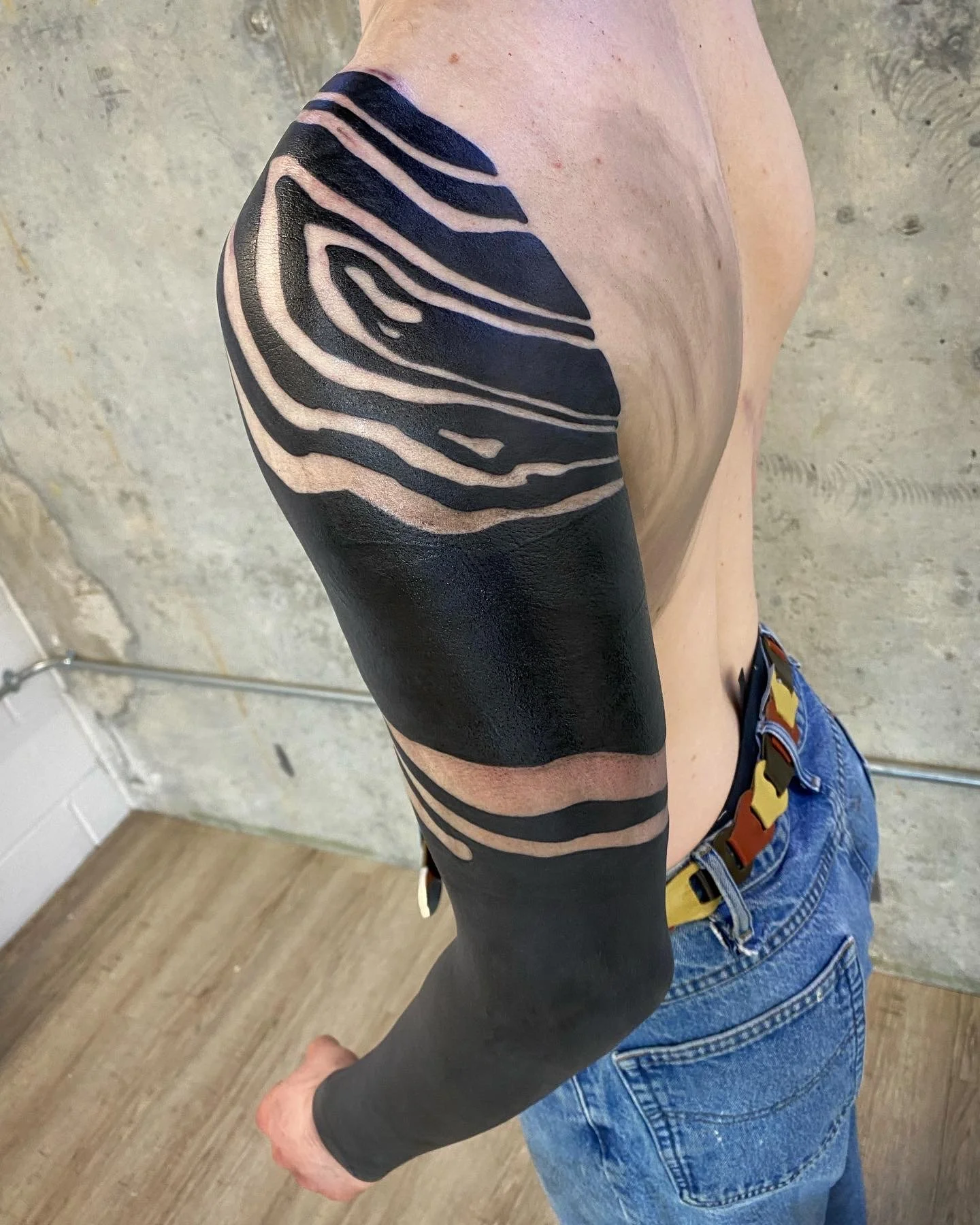 Blackout sleeve cover up tattoo by GÖRMEX, London blackwork tattoo artist, difficult cover up