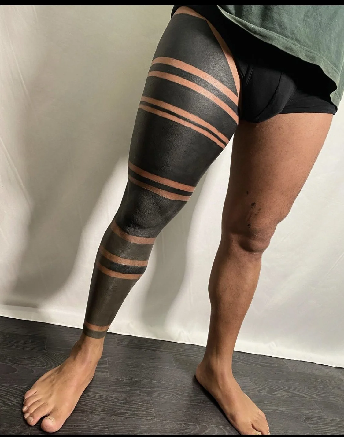 Blackout bands Maori inspired leg sleeve tattoo by Gormex, London tattoo artist