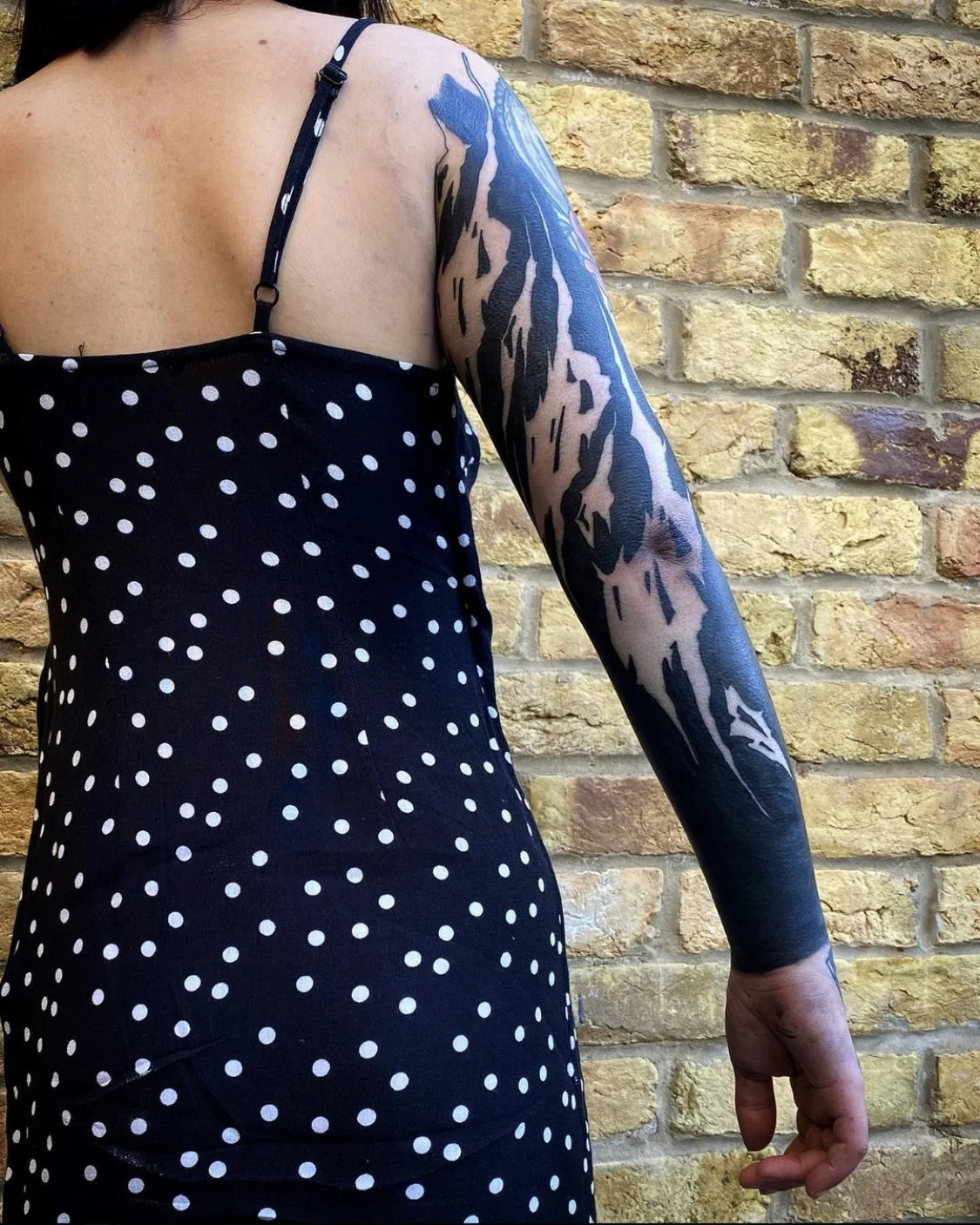 Blackout with negative script sleeve tattoo by Gormex, London tattoo artist