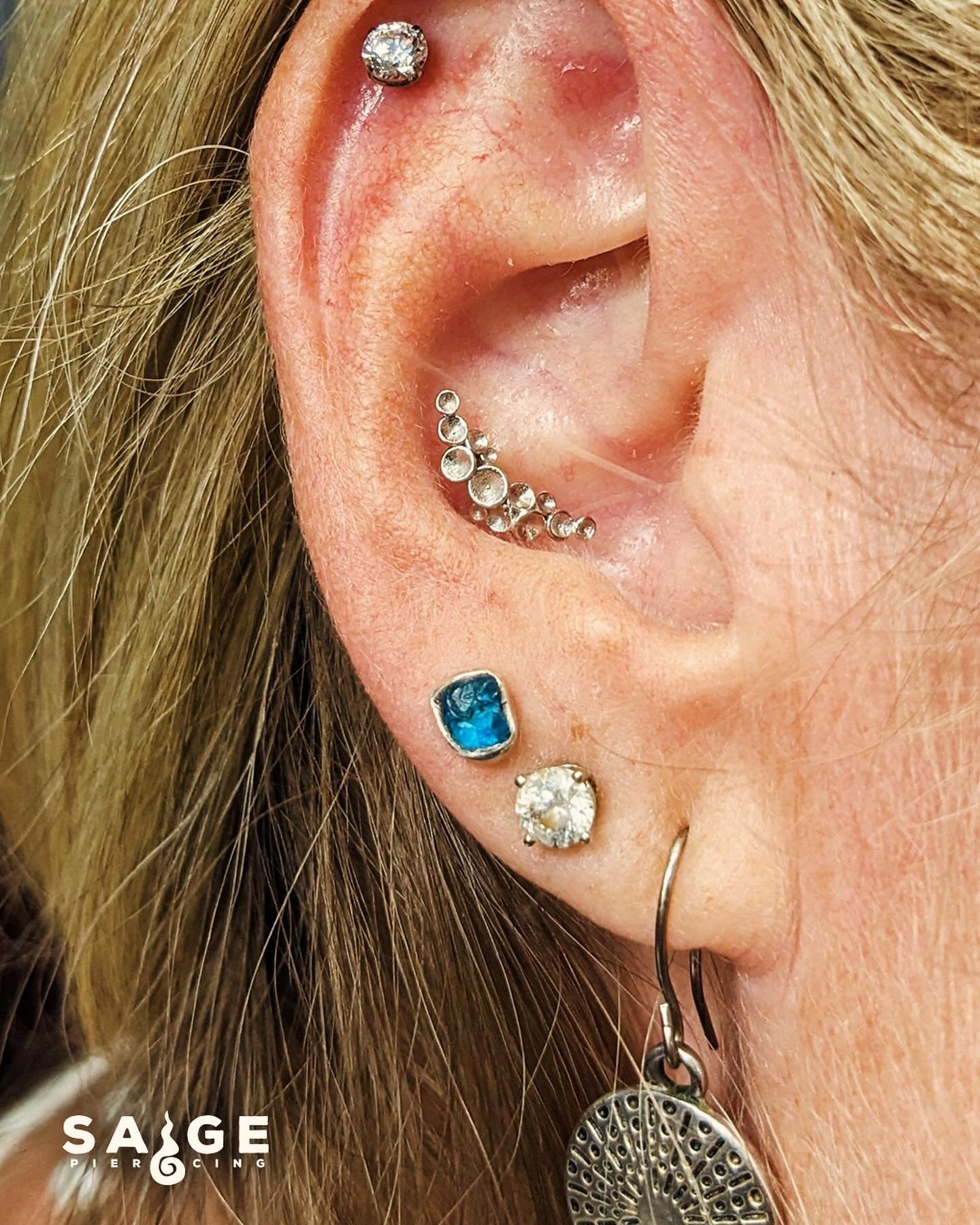 1) A dazzling new jewelry upgrade for her healed conch piercing. Featuring the Neptune from @tawapa jewelry in 14k white gold 

2) Check out these fresh new piercings! She got a daith with the Awaken ring and her flat piercing with the Starchild from