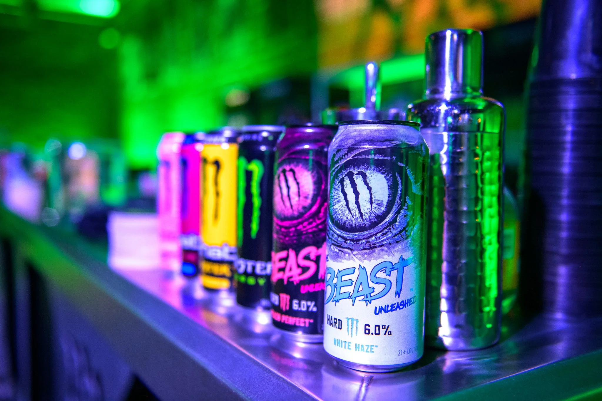 Monster energy drinks close up image with green lighting