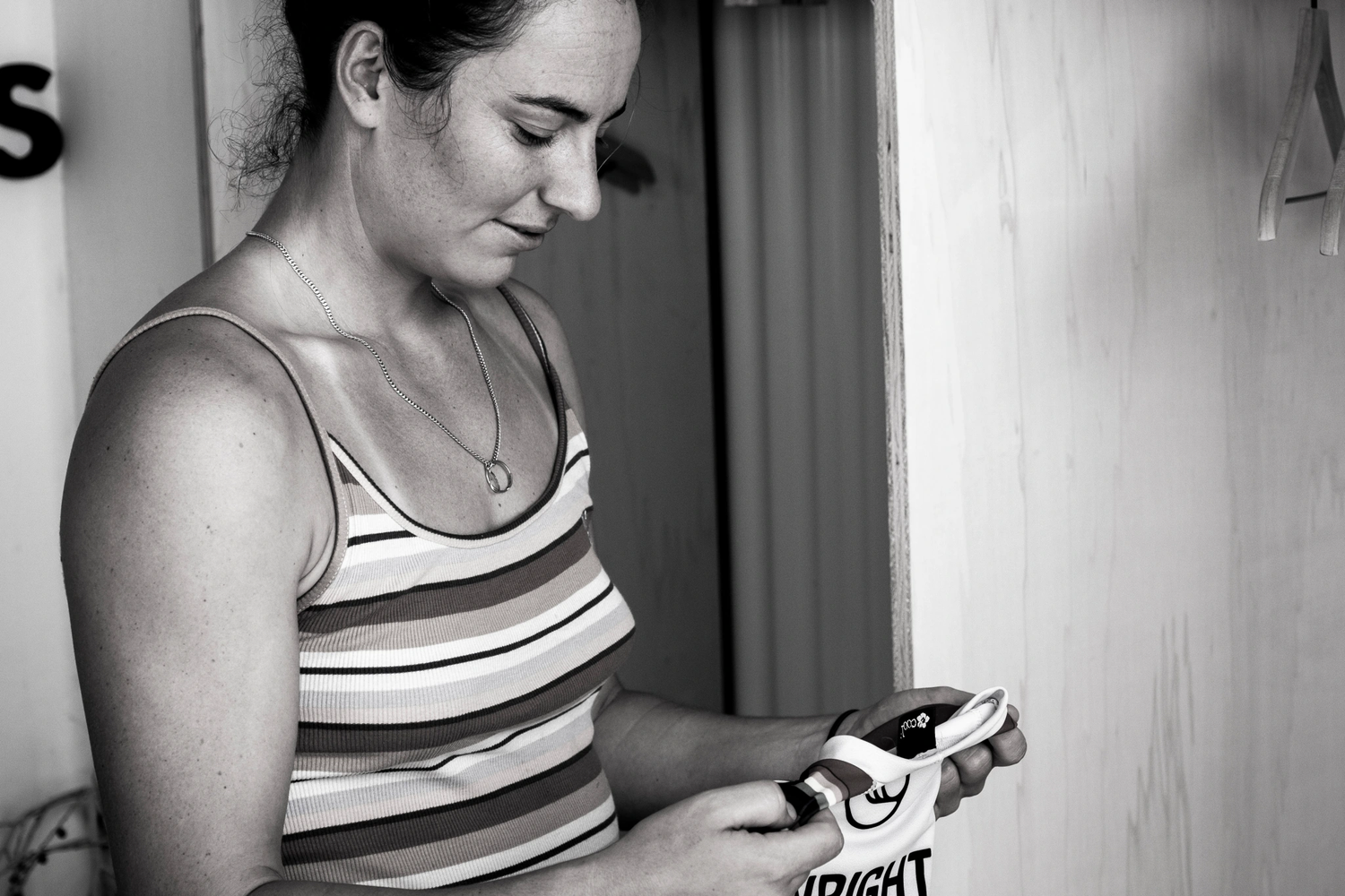 Image of professional surfer Tyler Wright looking down at her jersey.