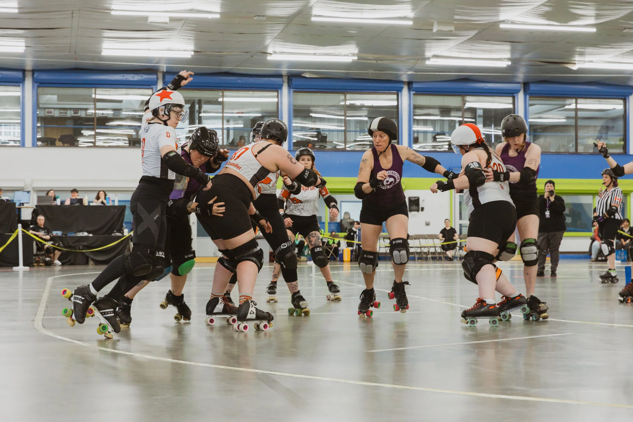 A skater balances on their toes to avoid going out of bounds as others surround them in a high-energy Victoria BC action scene.