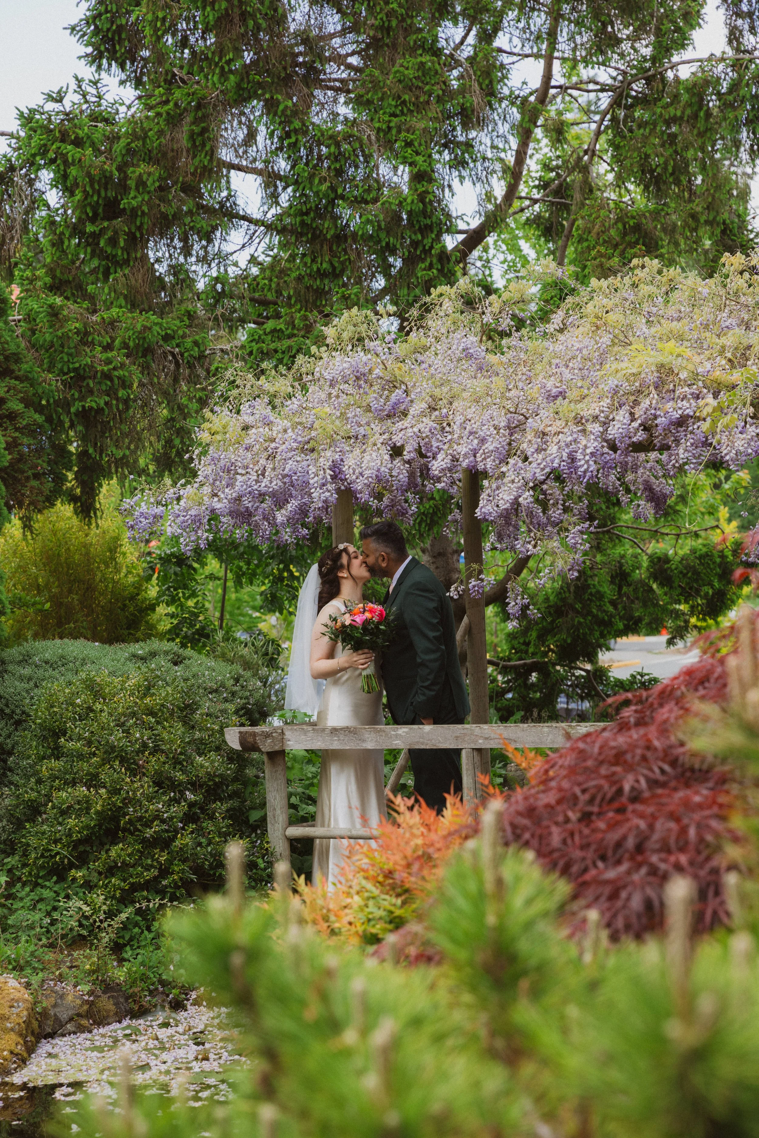 Victoria BC Wedding Photographer | Couple Kissing Under Lilac Trees
