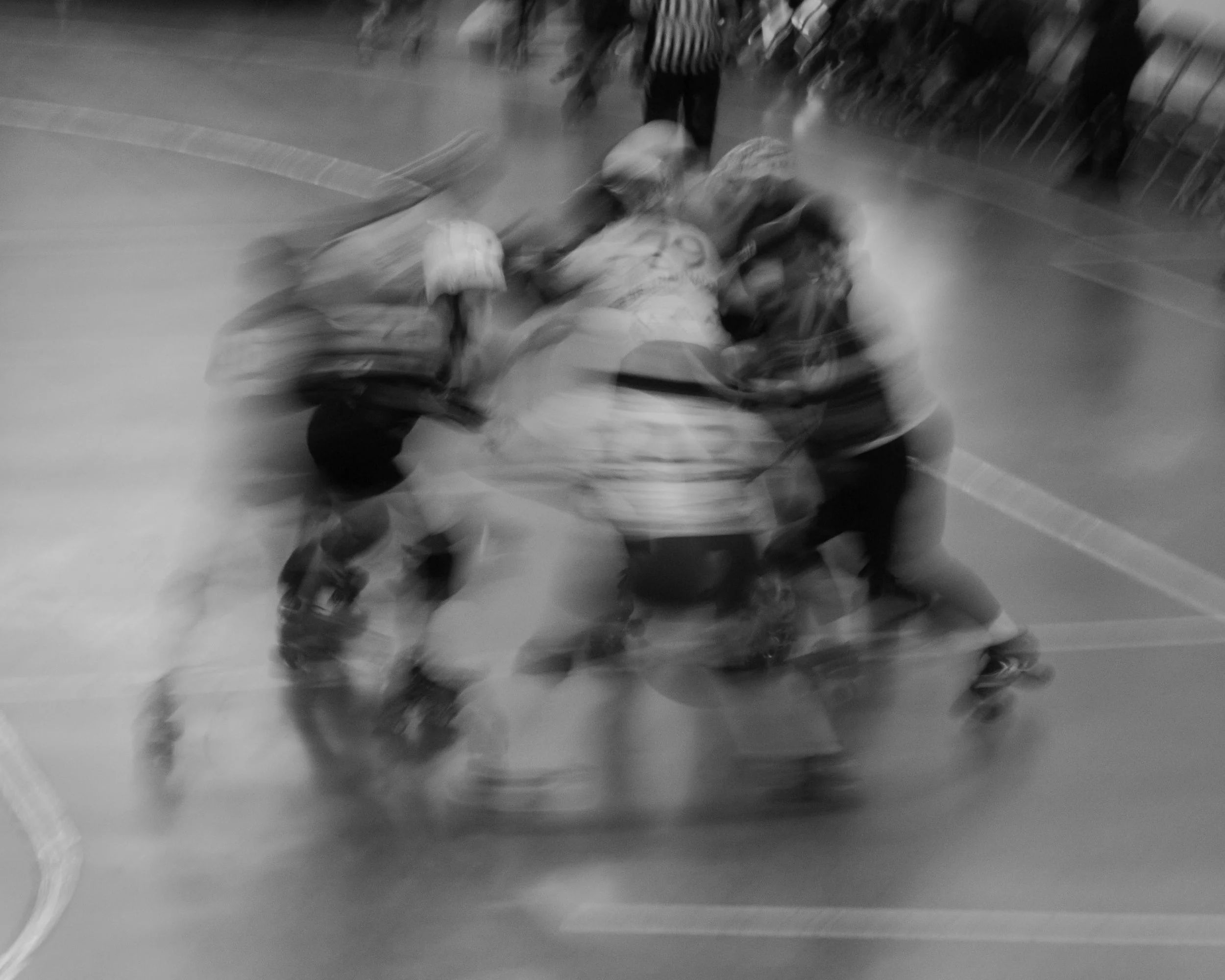 Black and white shutter drag image capturing the chaotic movement of teams trying to stop one another during a match in Victoria BC.