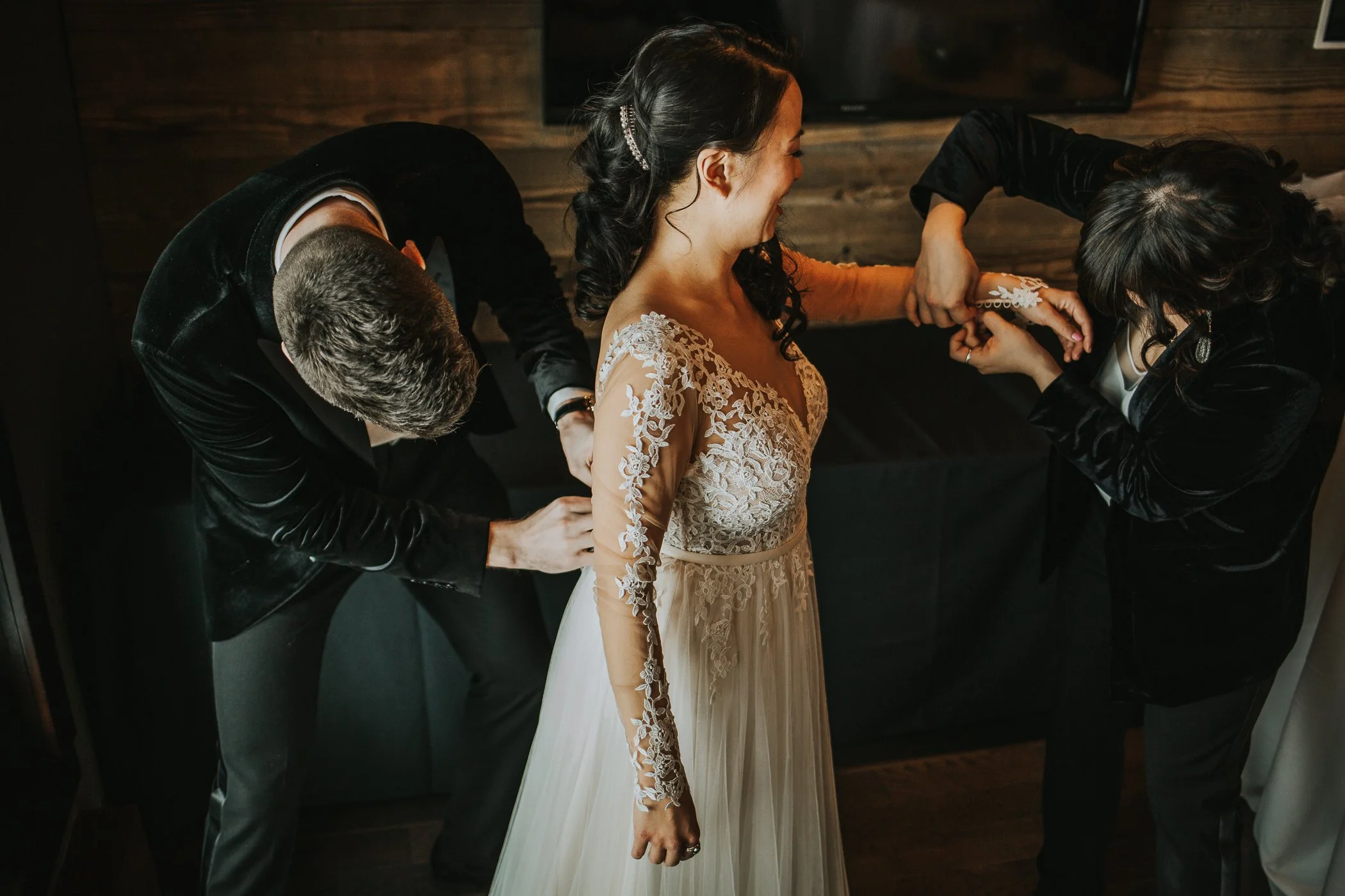 Bride getting ready in her Stella York lace sleeve winter wedding dress