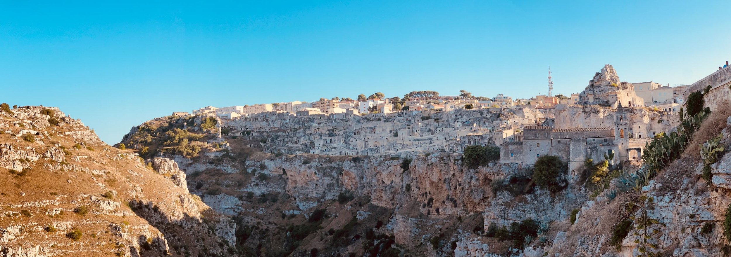 Matera, perched on a rocky hillside in Basilicata, southern Italy, is one of the world’s oldest continuously inhabited cities. Go there and stay in a converted cave. Hike across the valley in the morning.