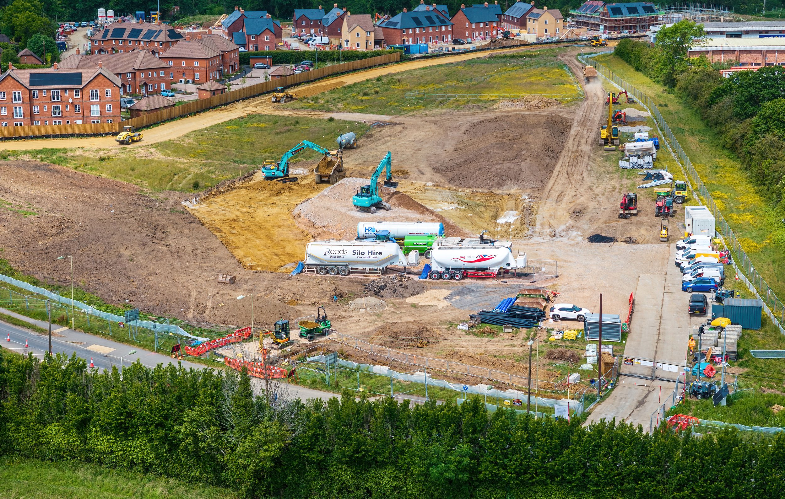 A drone image of a construction site with multiple construction vehicles