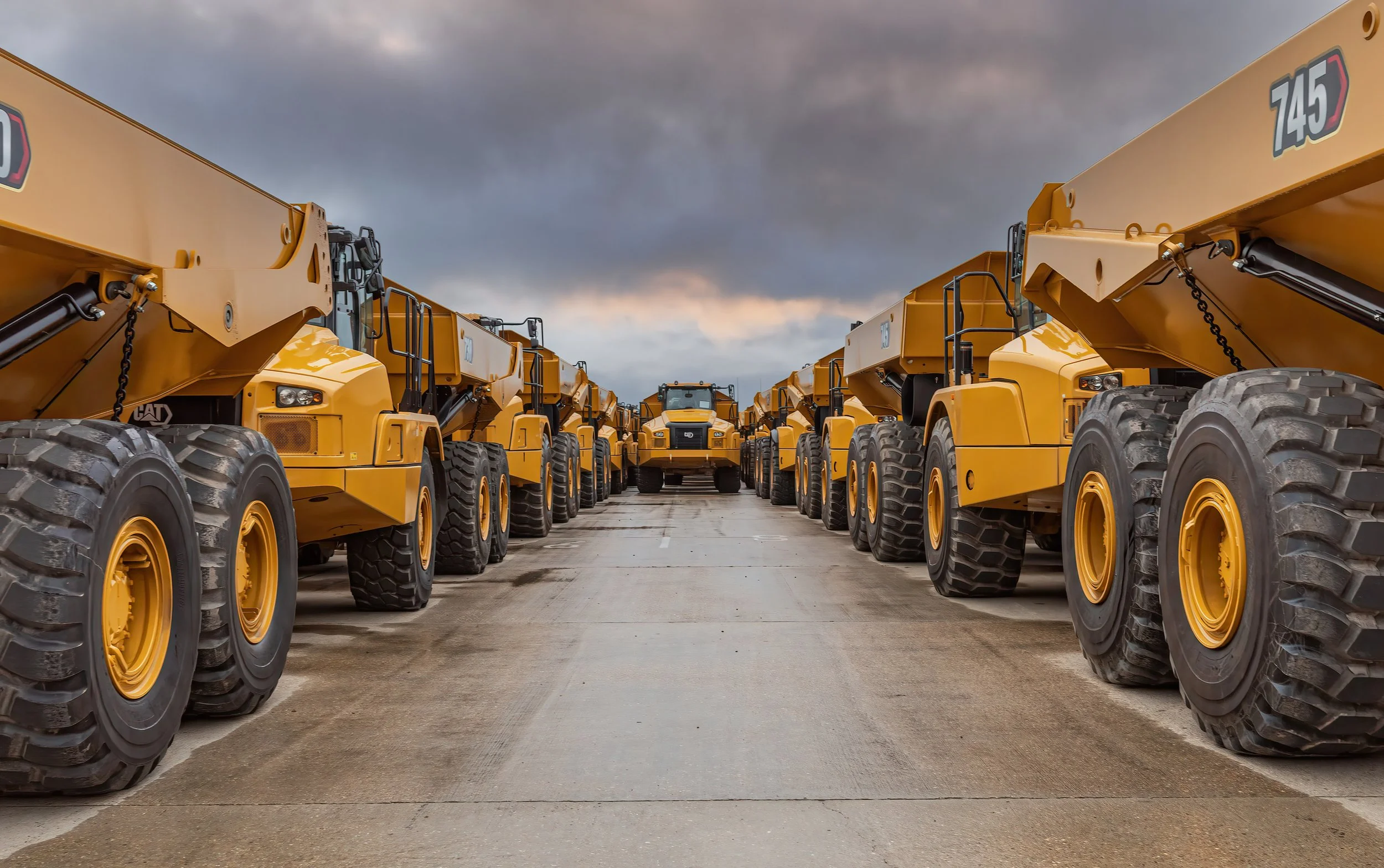 Image of construction vehicles lining up for shipping