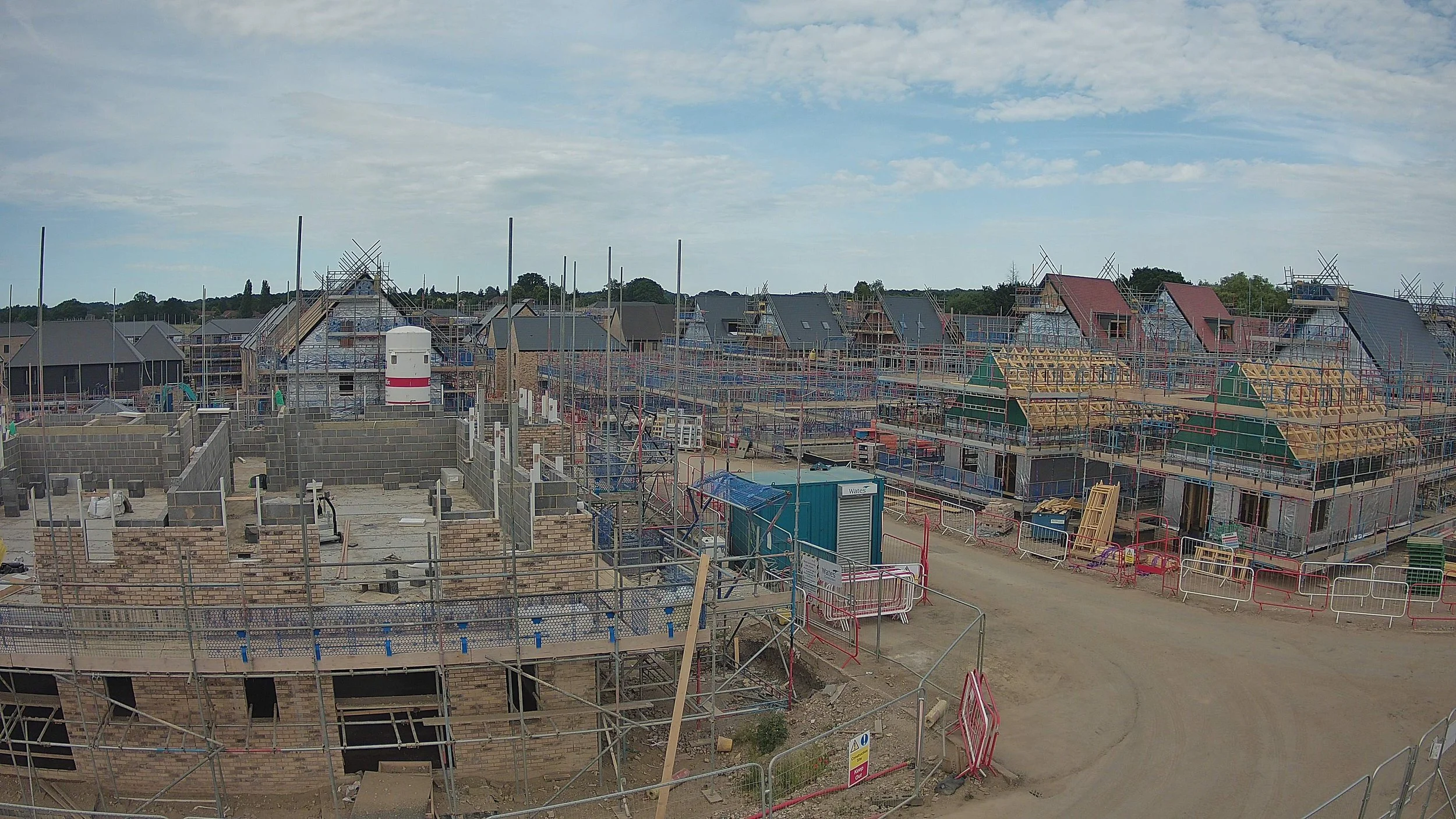 Fixed construction time-lapse camera view showing housing development progress