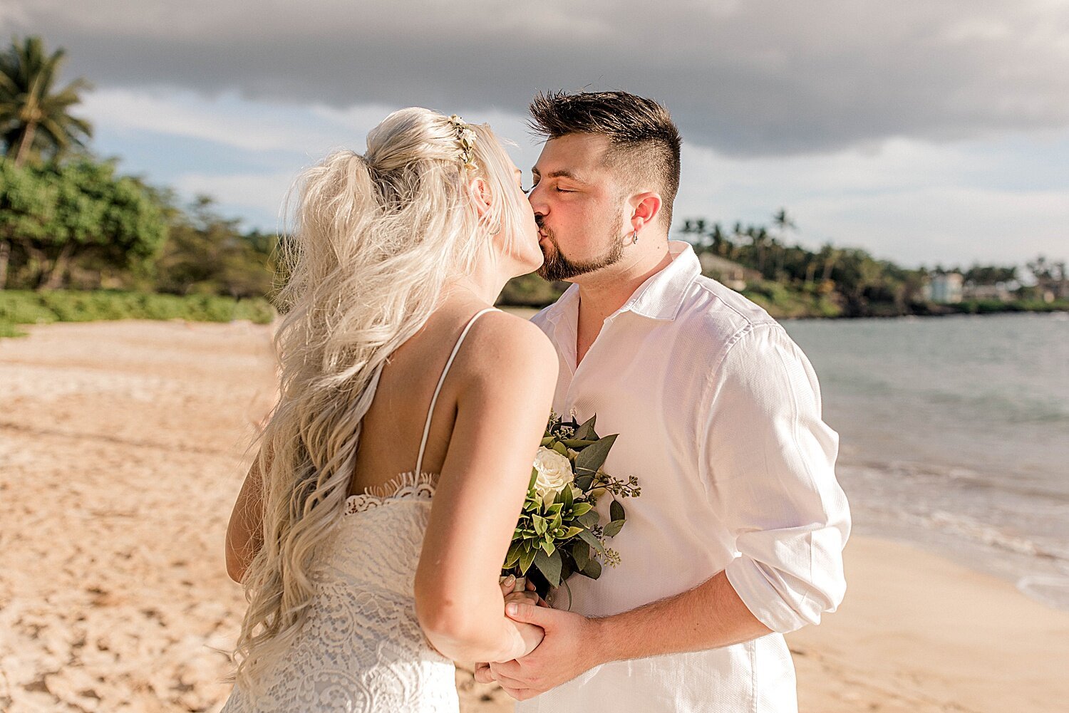 Bride and groom kissing during Maui beach elopement