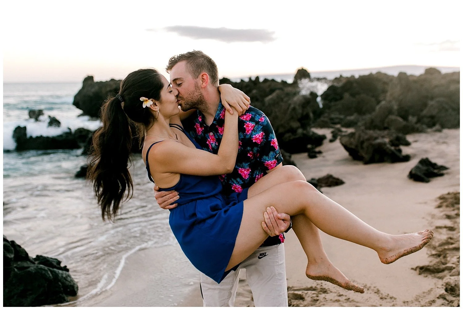 Man picking up woman on Maui beach