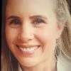 Close-up of a smiling woman, Joanne Cardone, with blonde hair and light blue eyes.