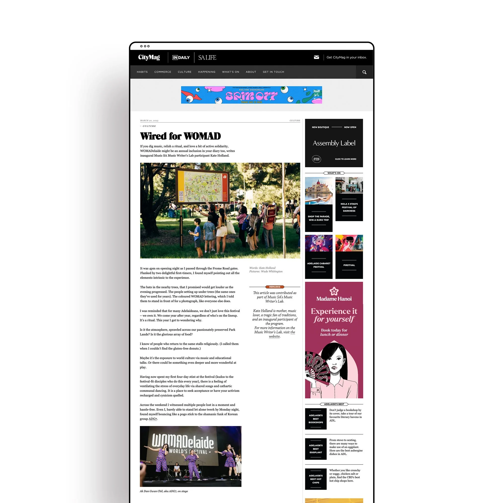 Screenshot of a webpage from CityMag featuring an article titled 'Wired for WOMAD' with an outdoor scene of people at a park, looking at a large map or informational sign, and a smaller photo of performers at WOMAD festival.