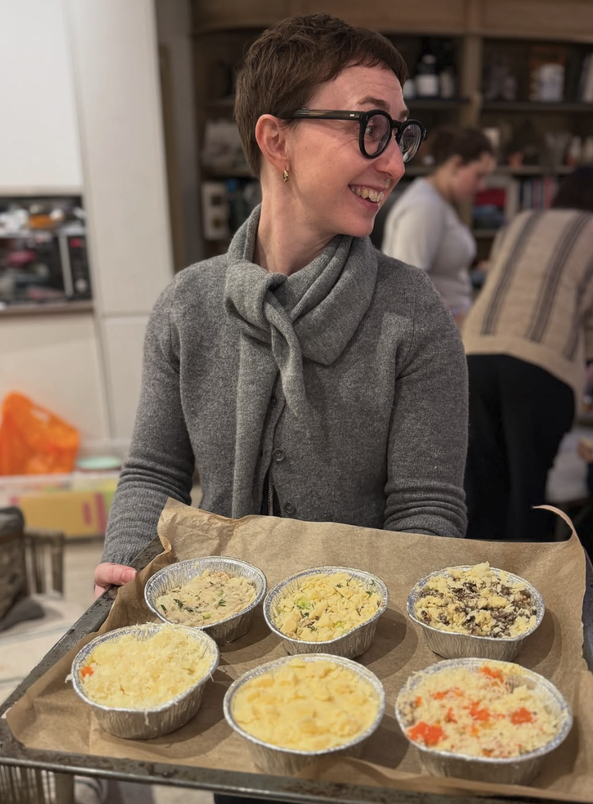 Cooking teacher holding freshly prepared dishes at Brood.