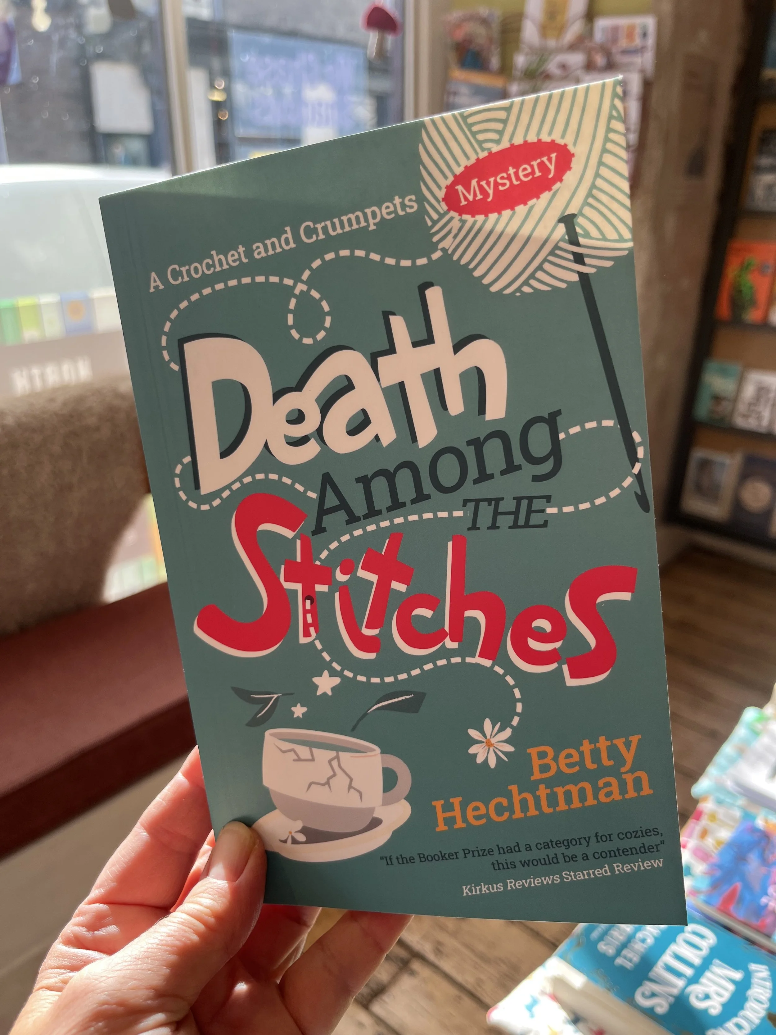 Death Among The Stitches by Betty Hechtman