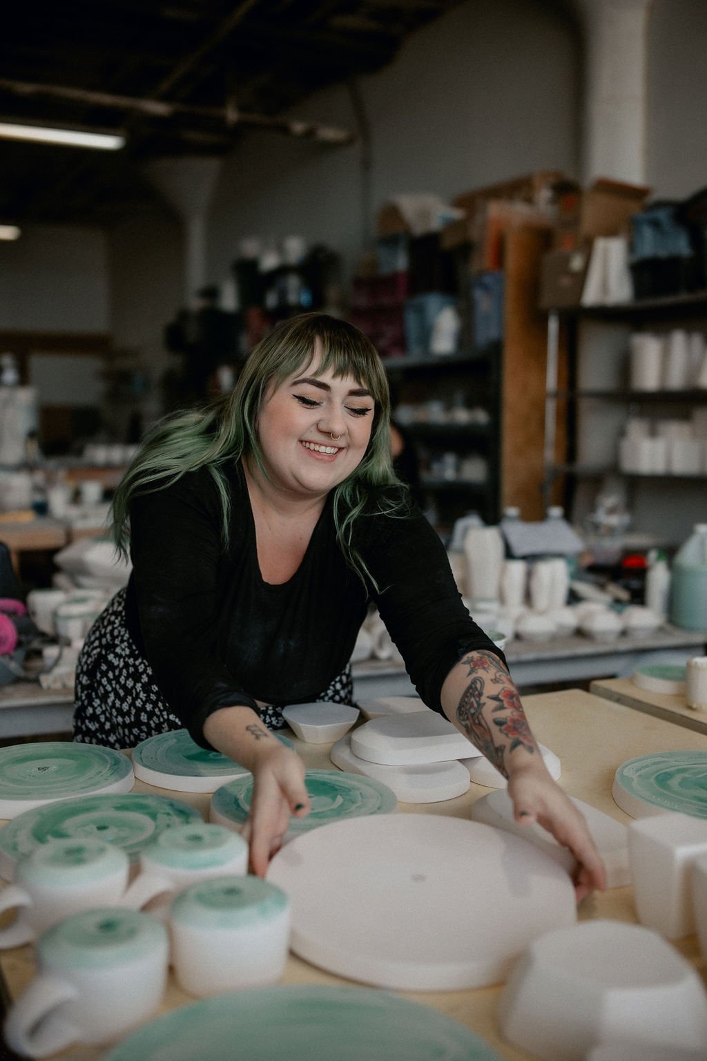  Lauren HB Studio production artist hand crafting pottery onsite at Lauren HB Studio. 