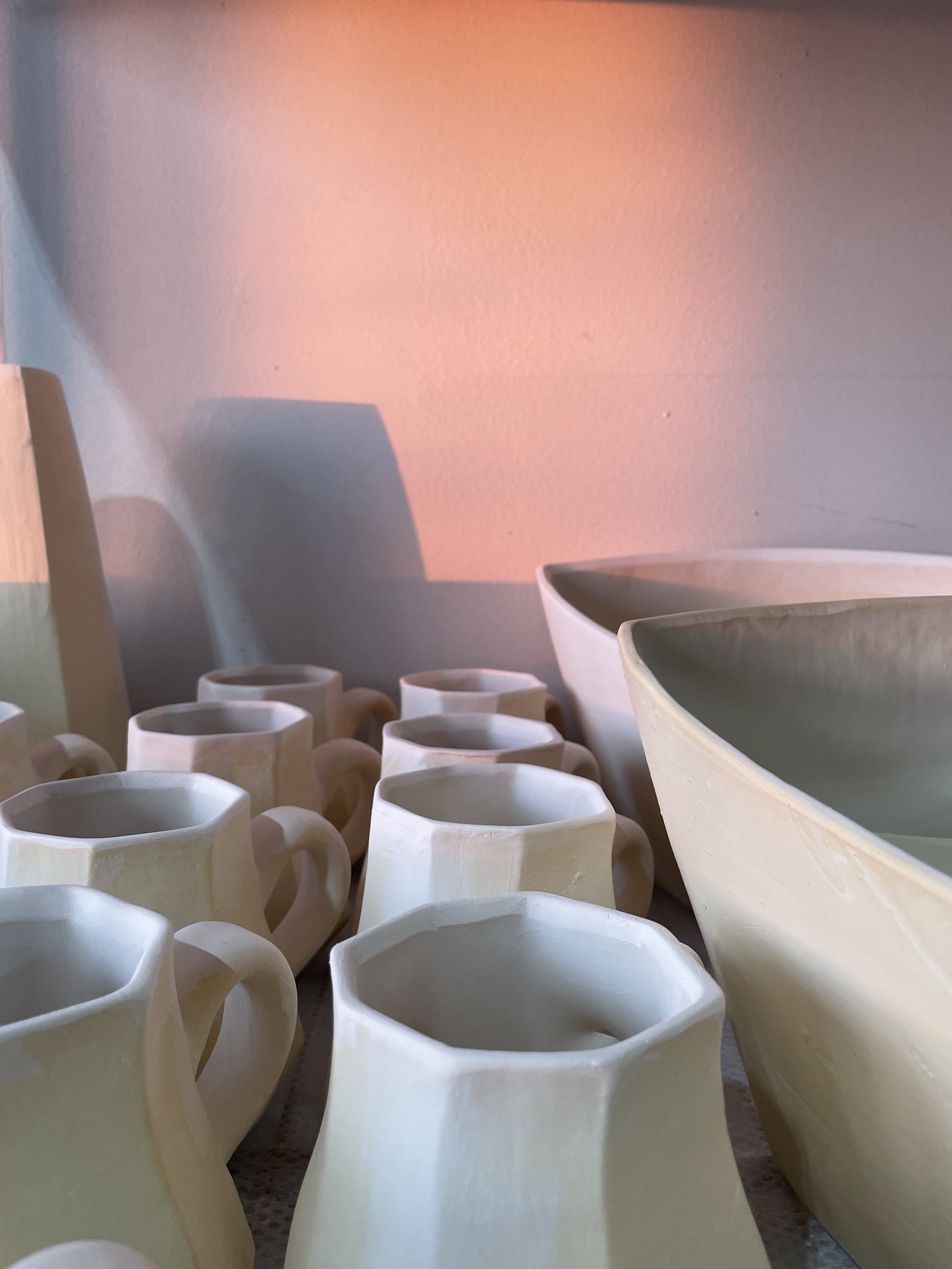  A picture of eight ceramic coffee mugs and two large bowls made by Lauren HB Studio 