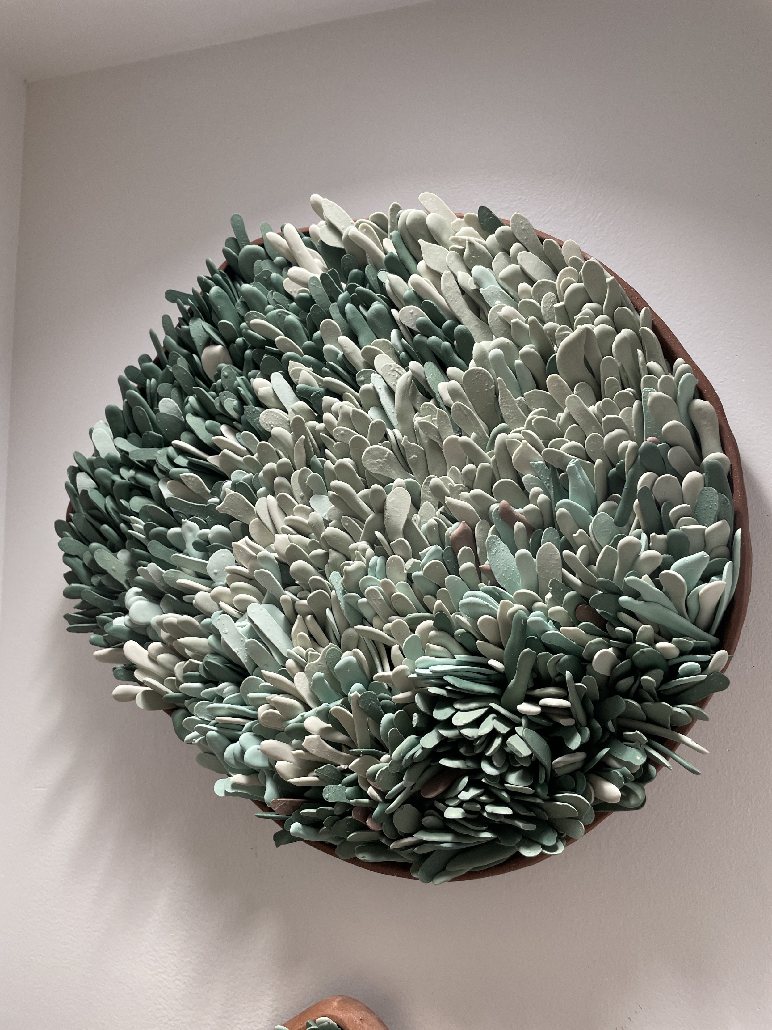  Round wall art sculpture with shades of green pieces created by Lauren HB Studio availably for purchase online and display 