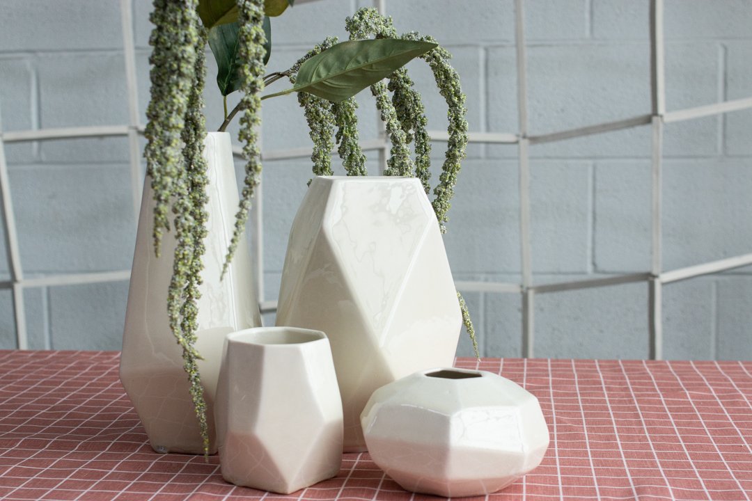  Four white geometric vases of varying sizes in the Juniper collection made by Lauren HB Studio available for purchase and commission 