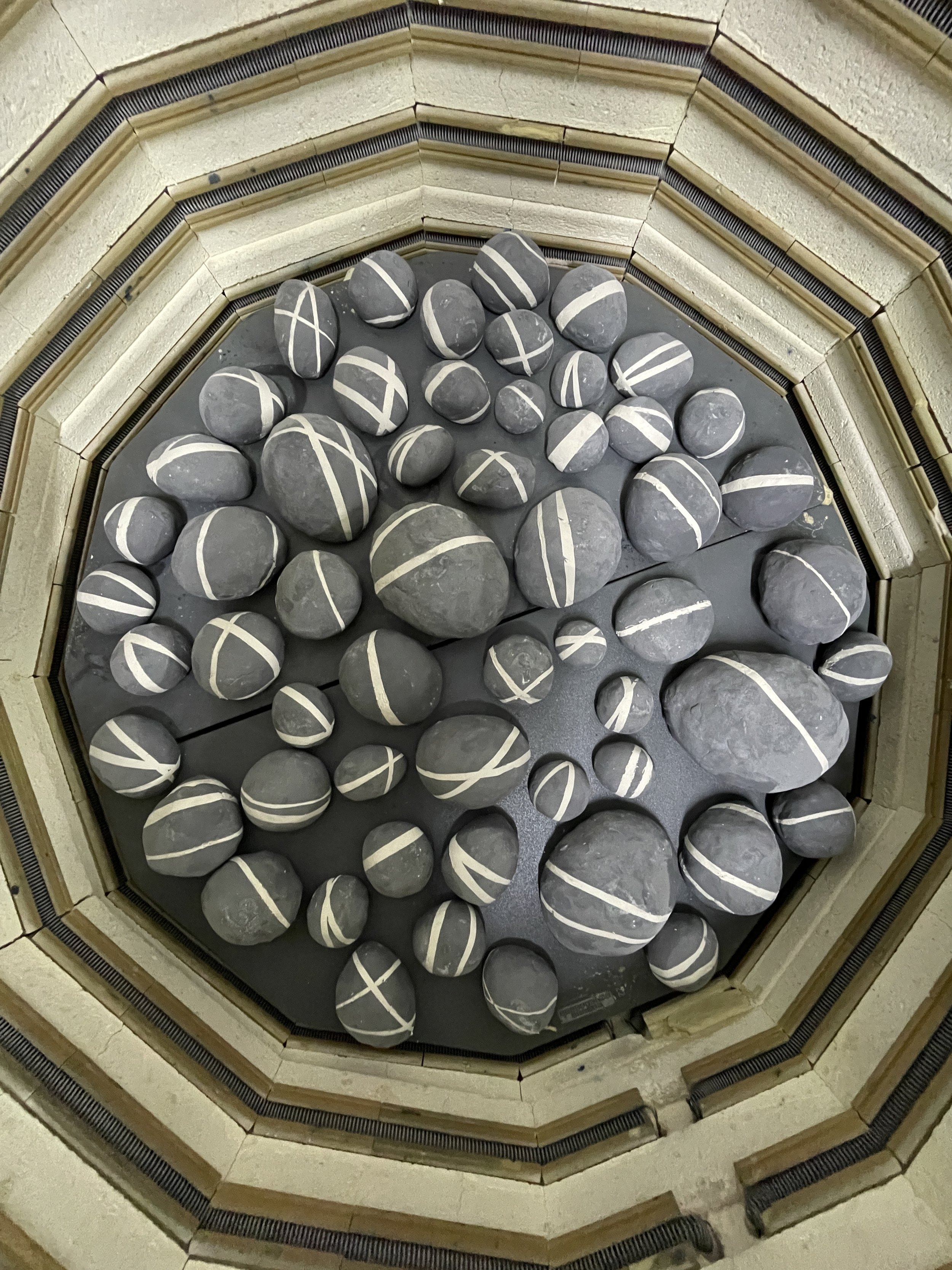  An image of black rocks with white lines through them portrayed as artwork created by Lauren HB Studio available for public and private display 