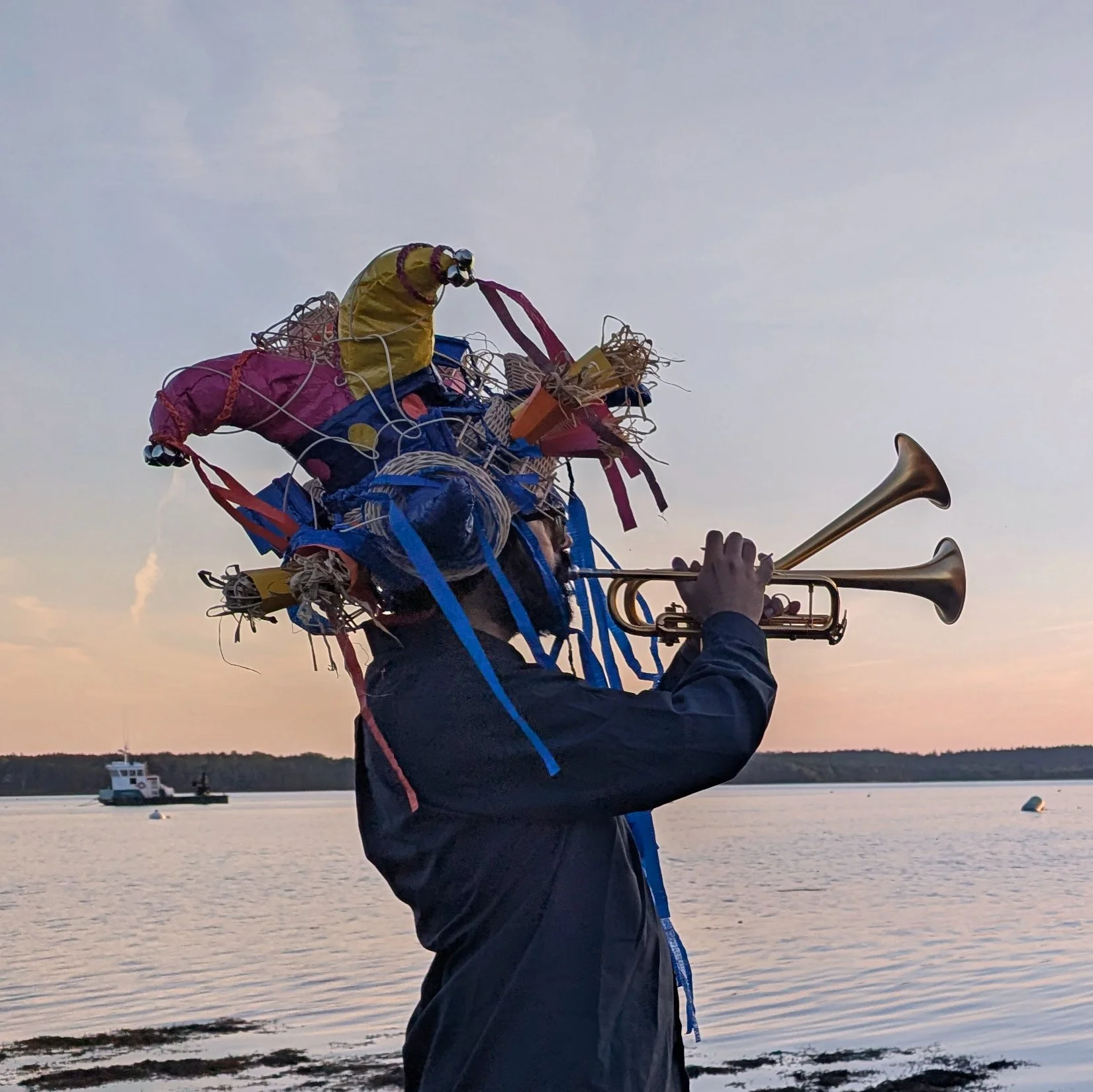David Aguila (trumpet), wearing hat  in performance as Her Love for the score "Love Letters", Tides Institute, June 2026. Veil / Plastic, paper, reed. 