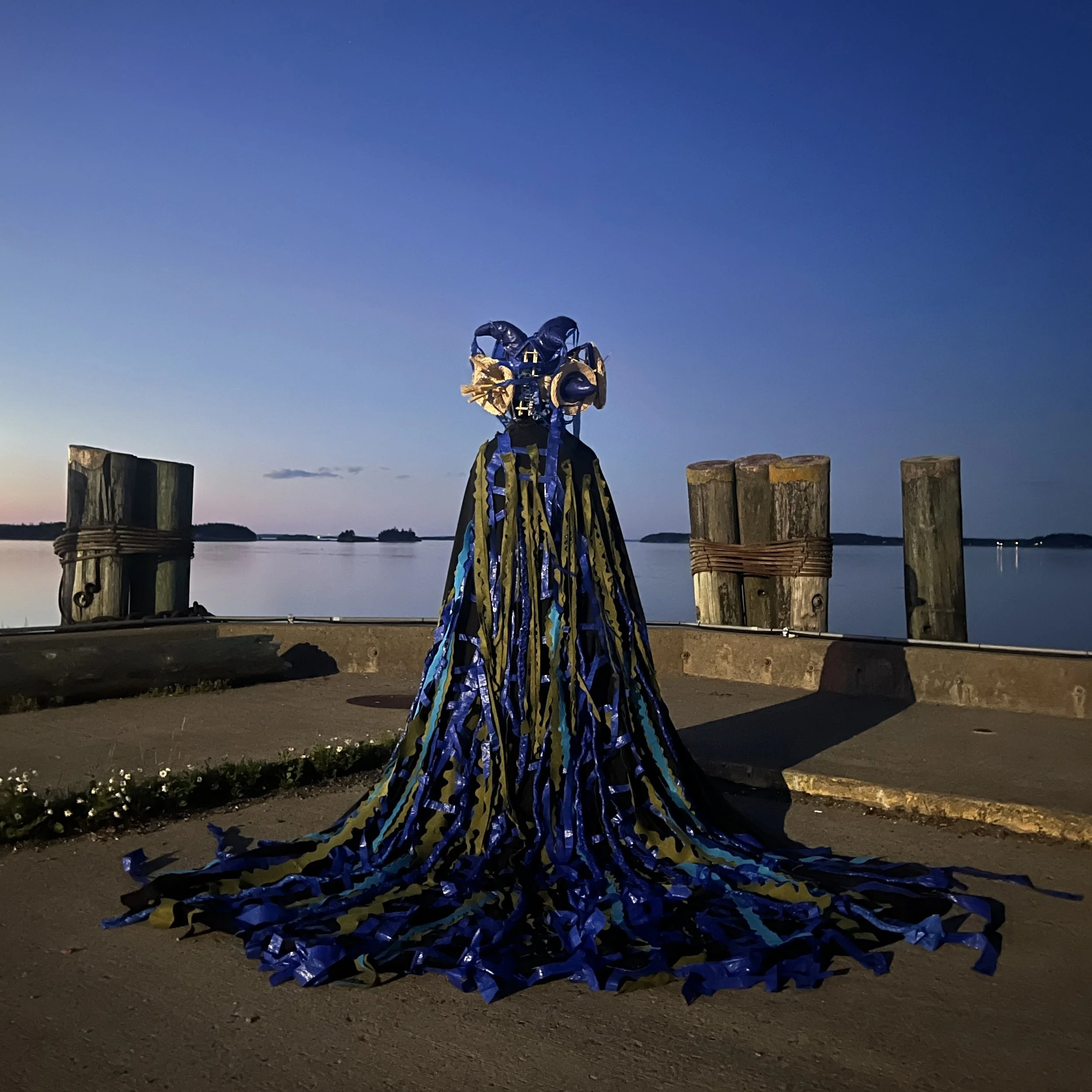 Natalia Merlano Gomez (voice), wearing hat and veil in performance as The Queen of Algae for the score "Love Letters", Tides Institute, June 2026. Veil / Plastic, felt, muslin. 
