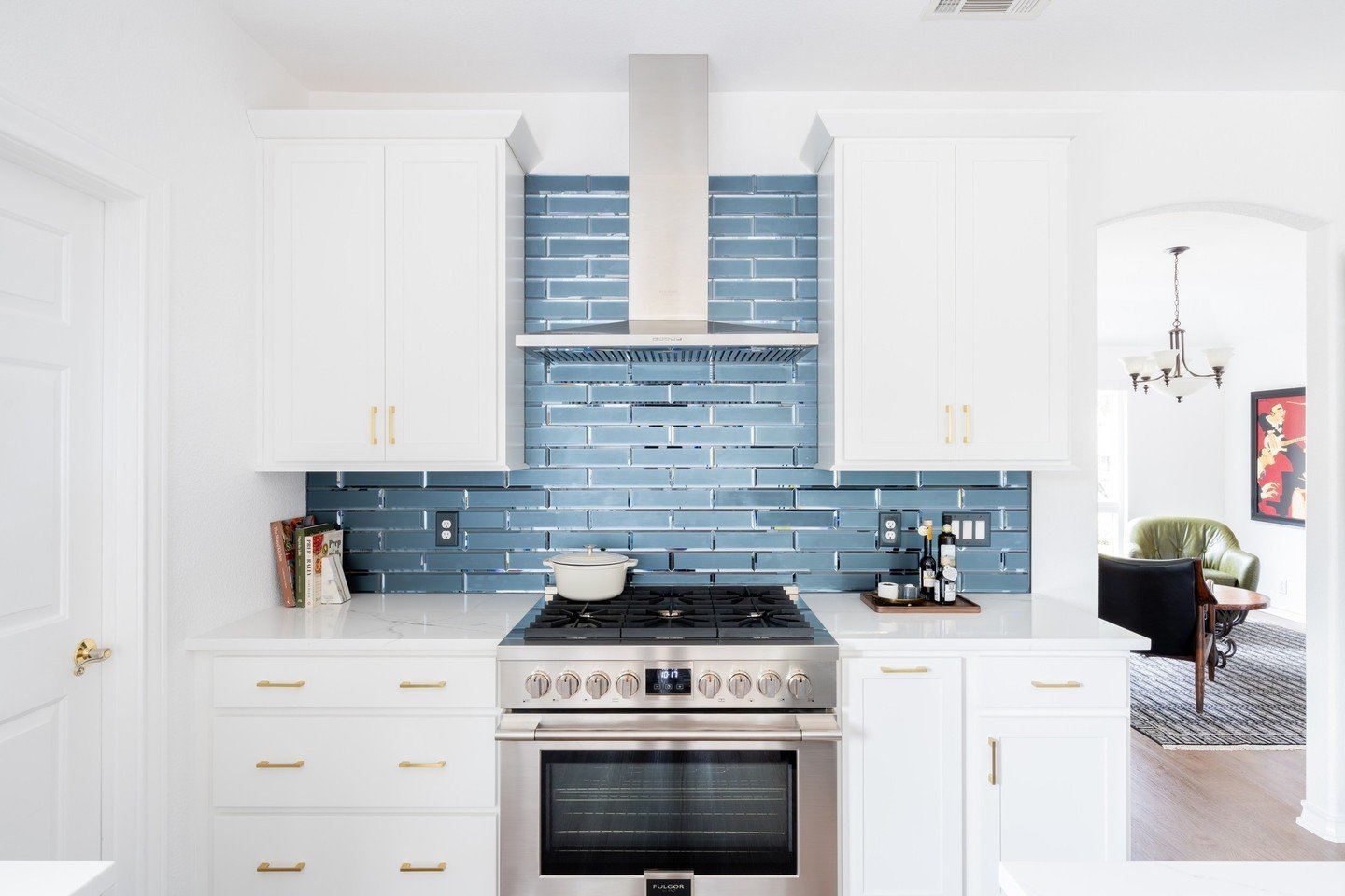 Breathe life into your kitchen with the latest trend of bold colors&mdash;without overwhelming your space. Opt for a vibrant backsplash as your statement piece, just like this stunning shade of blue, balanced beautifully with neutral cabinetry. It's 