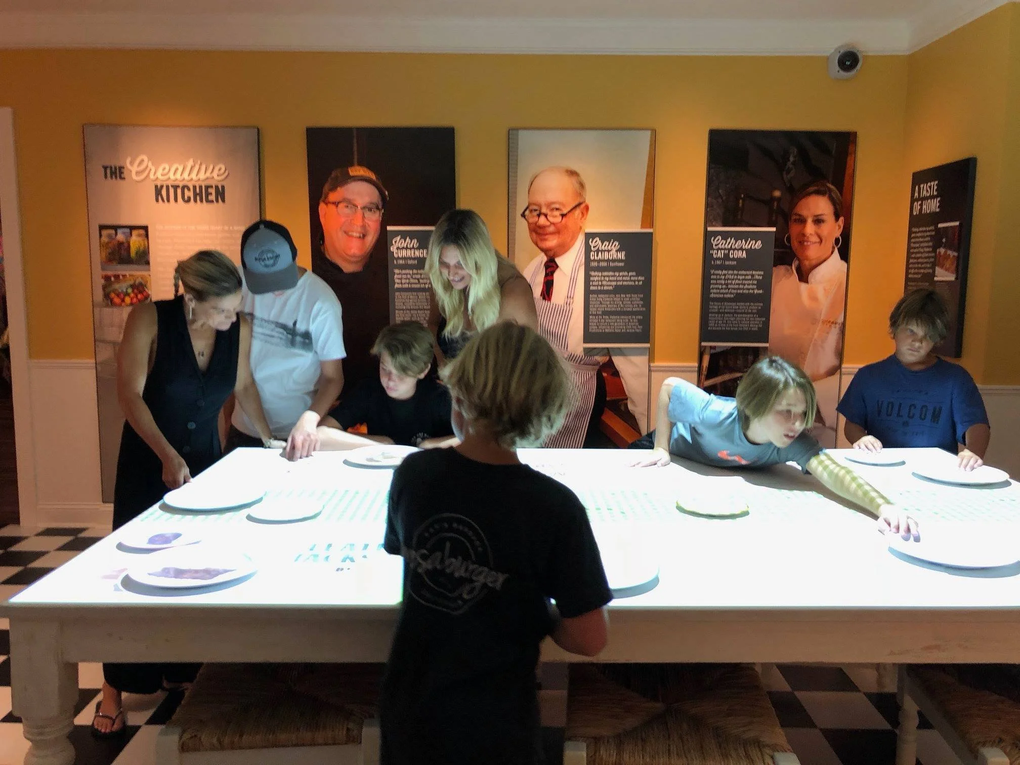 Iron Chef Cat Cora with her family playing with the interactive exhibit that features her.