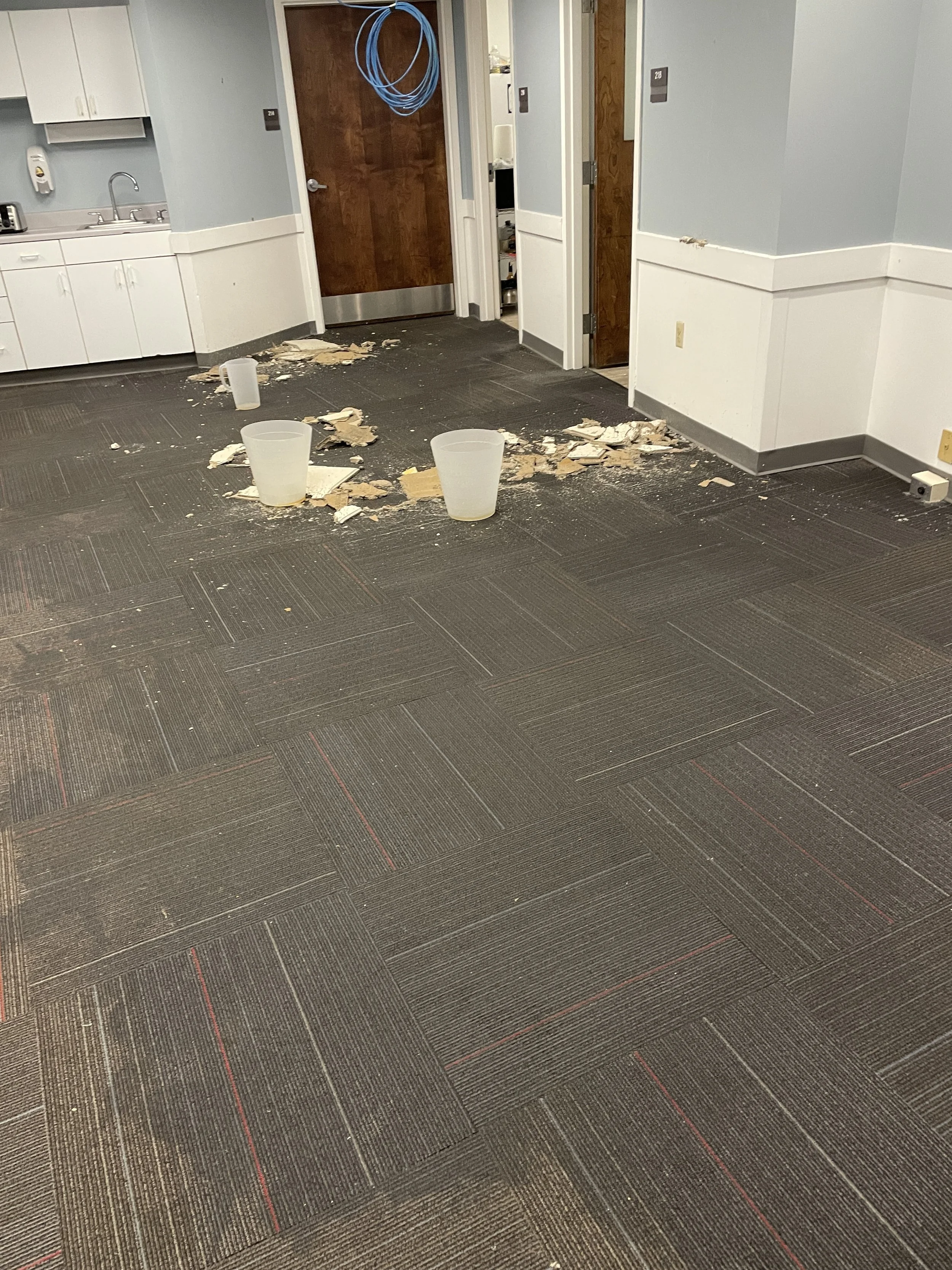 Water saturated carpet and fallen tiles