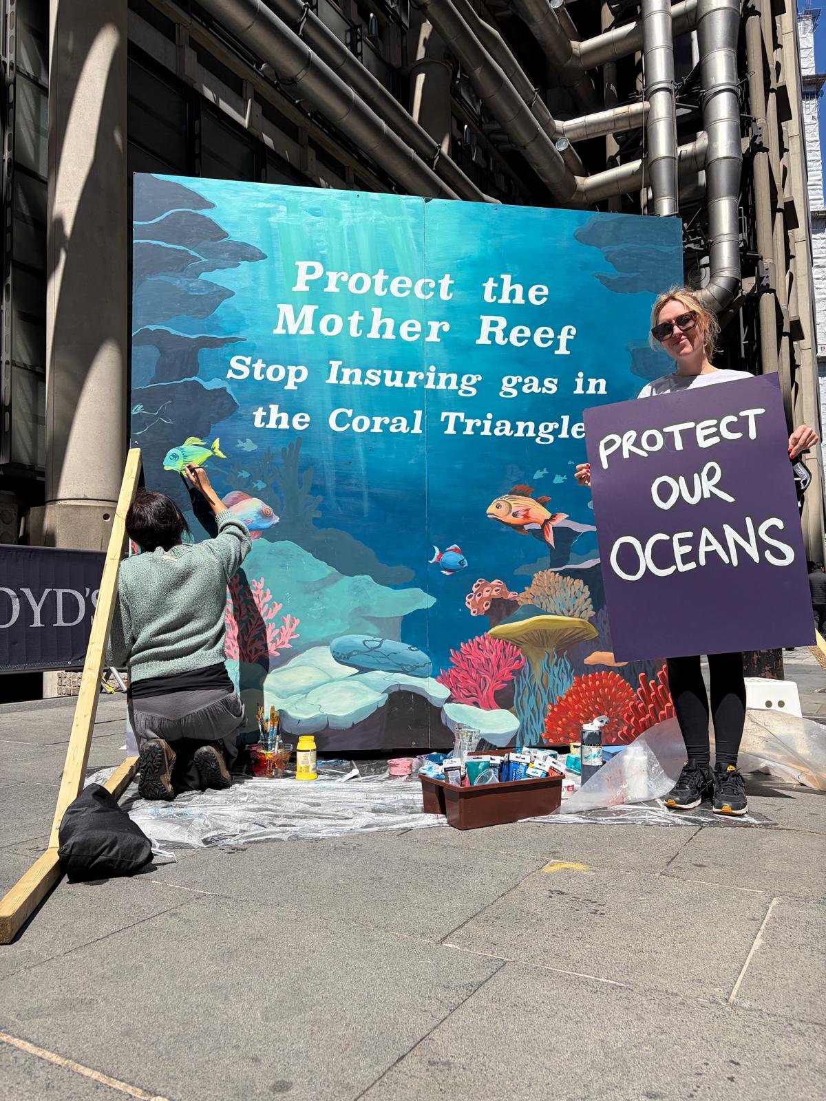 June 2026: MRU live paint a giant coral reef mural outside Lloyd's of London, calling on insurers within the marketplace to rule out underwriting polluting gas projects in the Asian Coral Triangle - a critical ecosystem. We handed out hundreds of fly