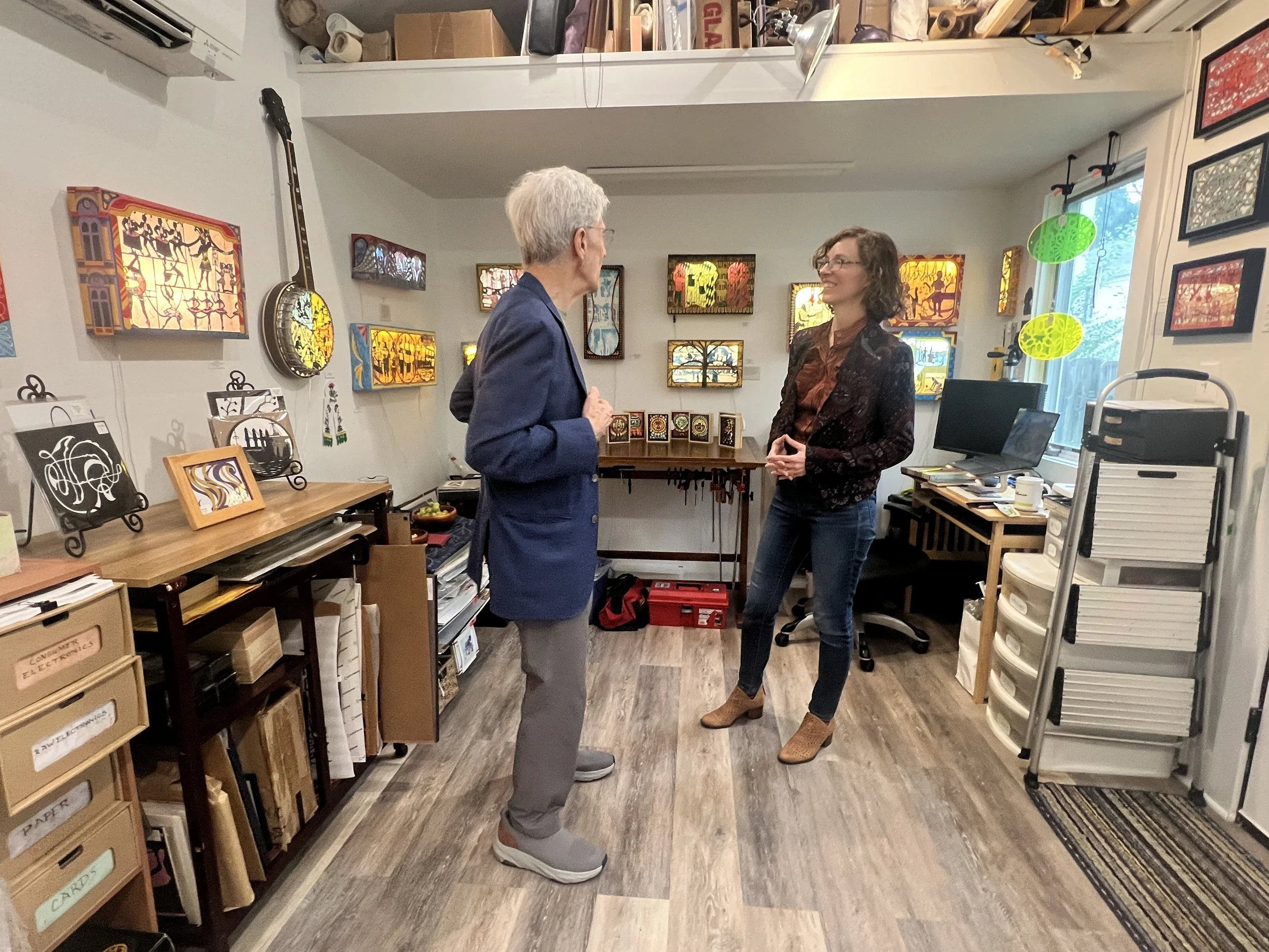 Joe Johnson visiting with Melanie Kehoss in her studio