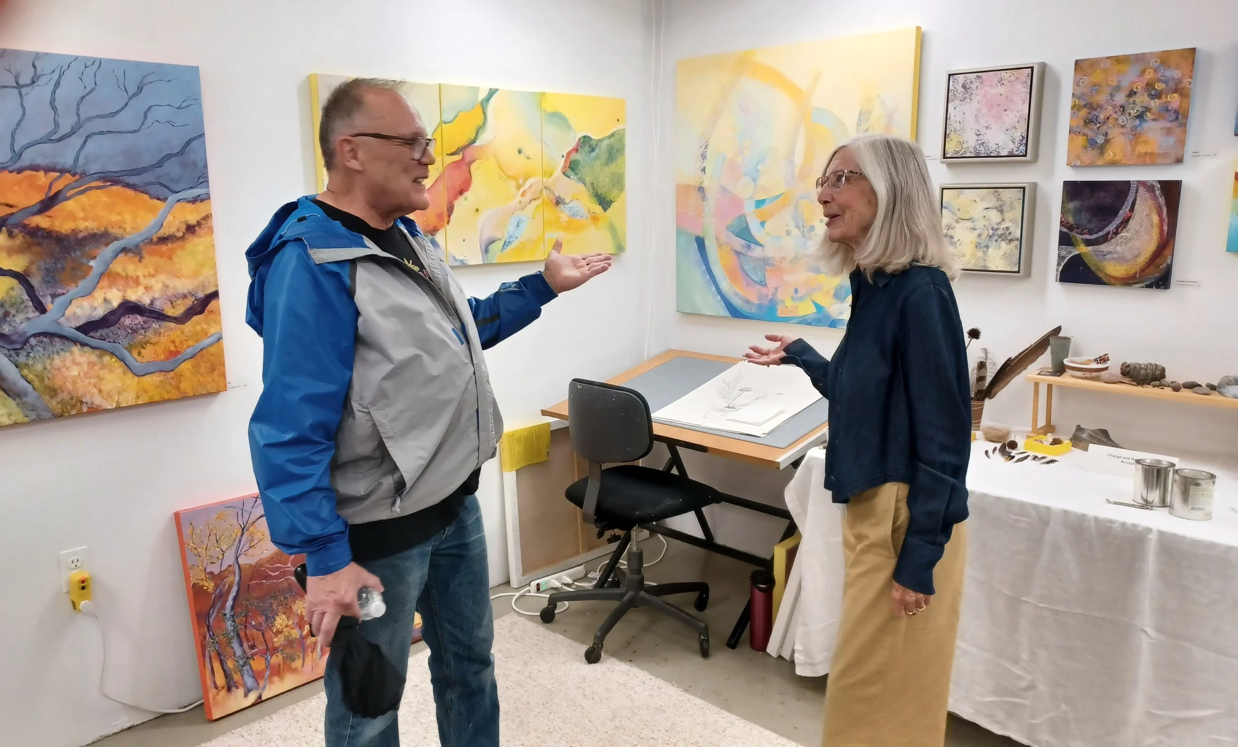 Bud Wilkinson chatting with Sharon Malley in her studio