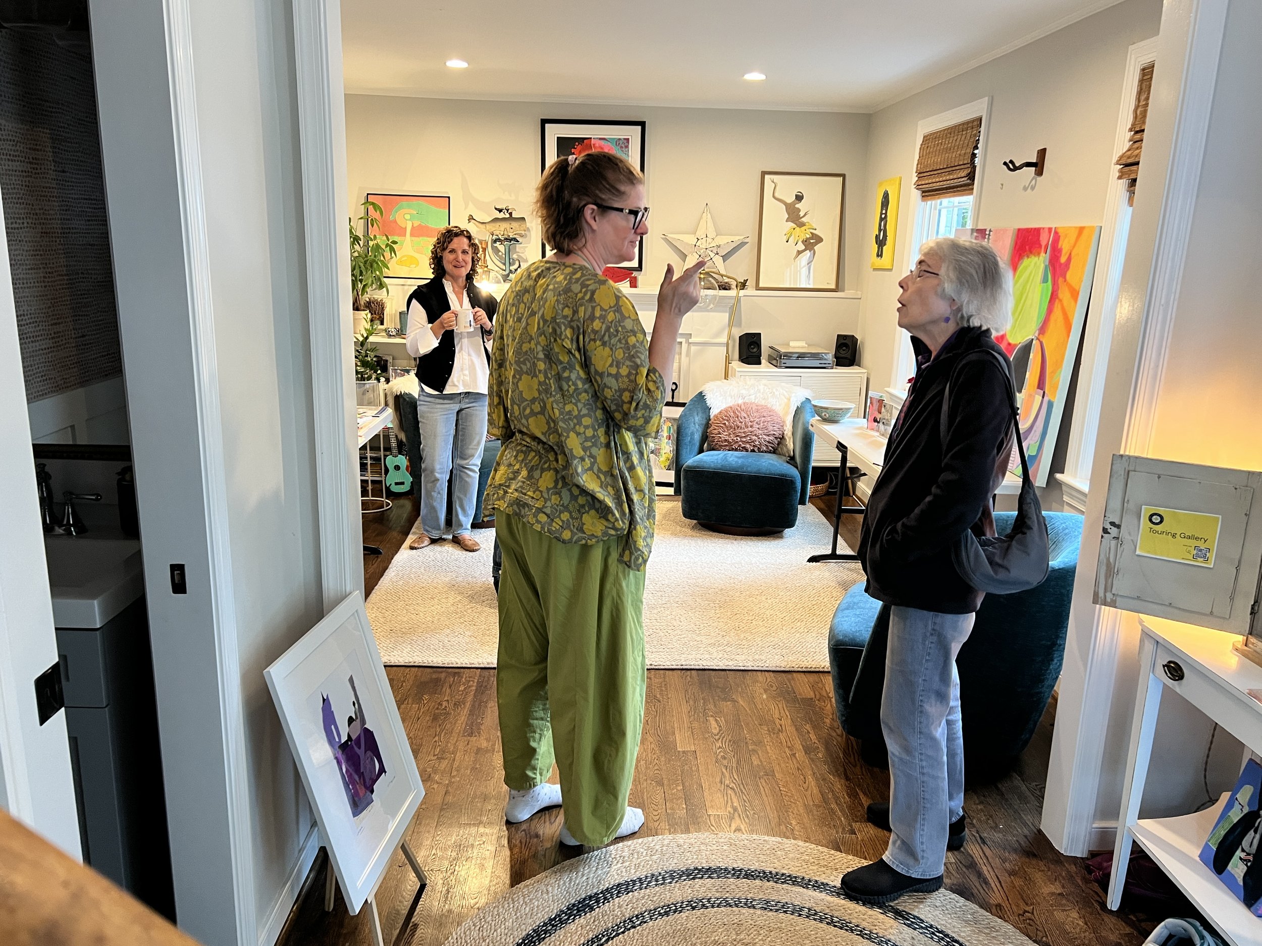 Molly McKracken chatting with a visitor in host Stacey Schwartz's home (driven inside by rain)