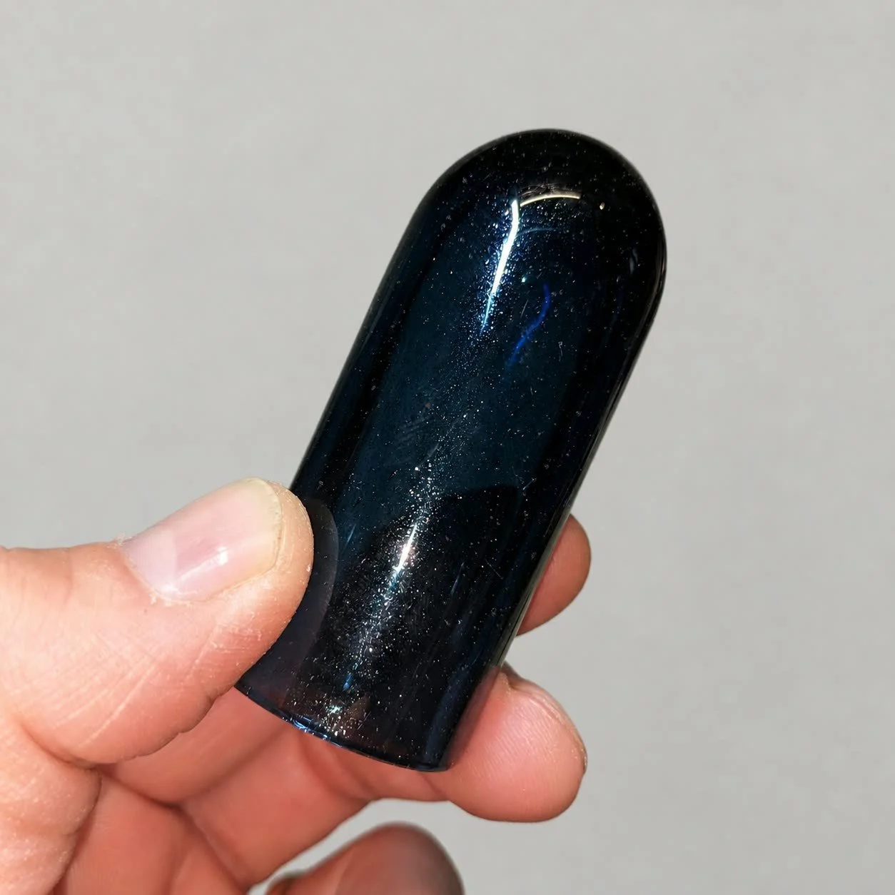 Blue Sparkle Ball Tip handmade glass guitar slide in Light Blue Stardust glass shown in hand
