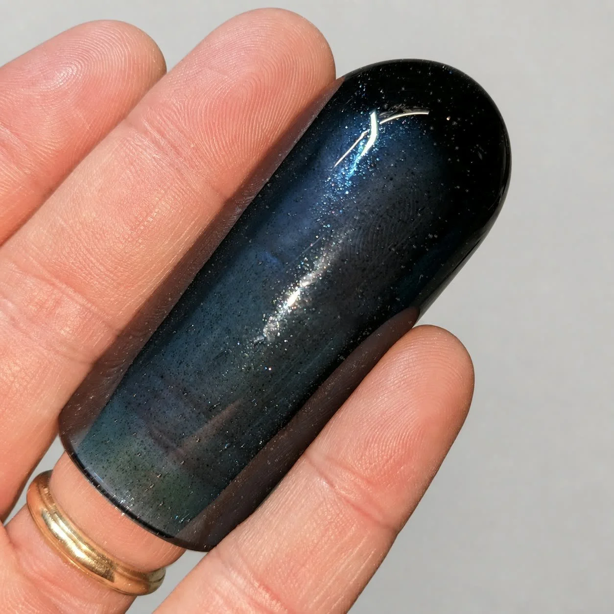 Reverse-side close-up of Blue Sparkle Ball Tip glass guitar slide with embedded sparkle