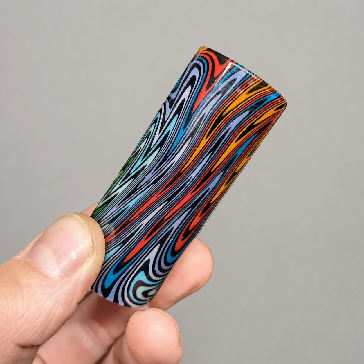 Reverse-side view of Rainbow Spiral non-tapered glass guitar slide showing stretched multicolor linework