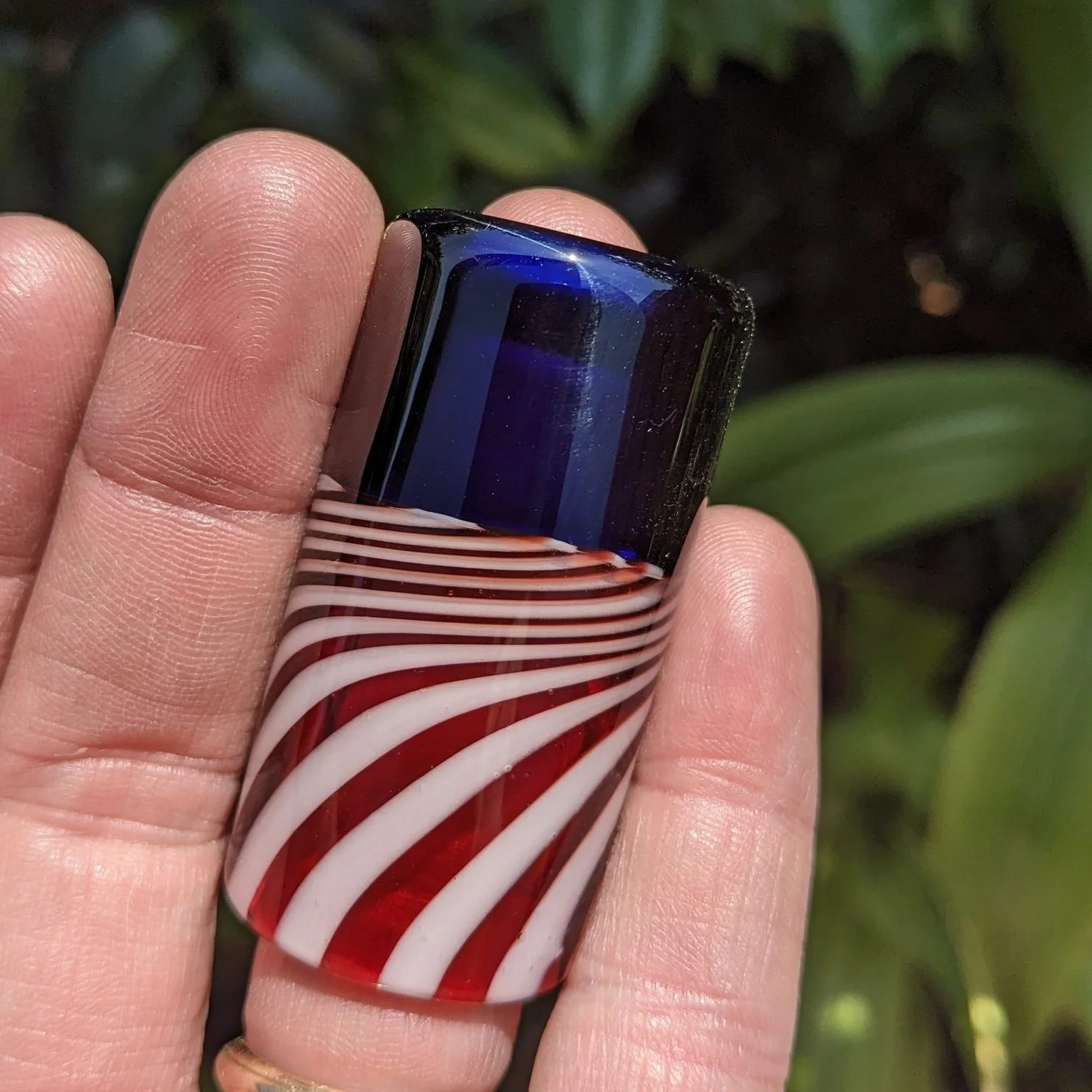 The Liberty Slide #3, handcrafted red white and blue glass guitar slide shown in hand