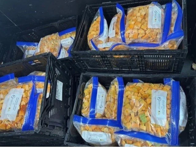crates of cubed winter squash in plastic bags