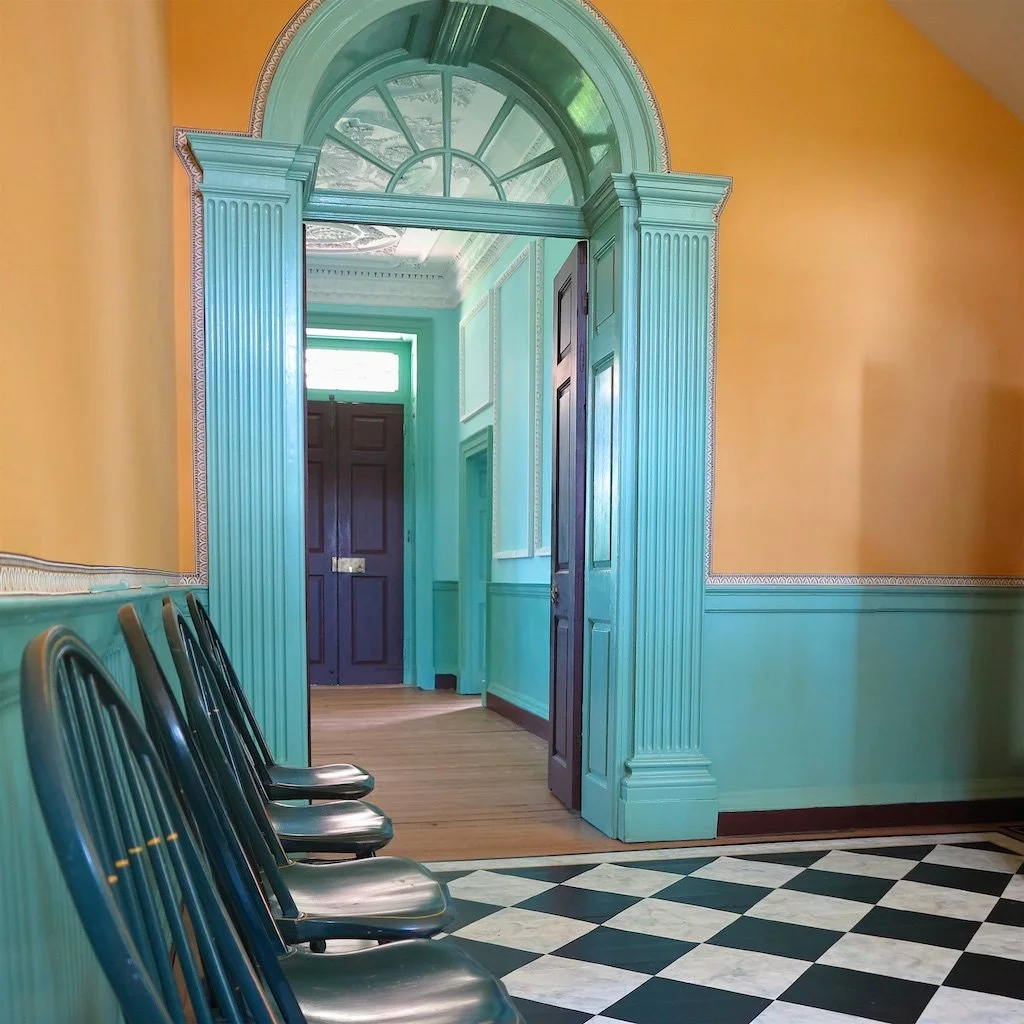 Archway in the front entry: The house is presented in colors used by wealthy colonists - not only were the ingredients to produce these colors expensive, paint and wall coverings would have all been heavily taxed by England.